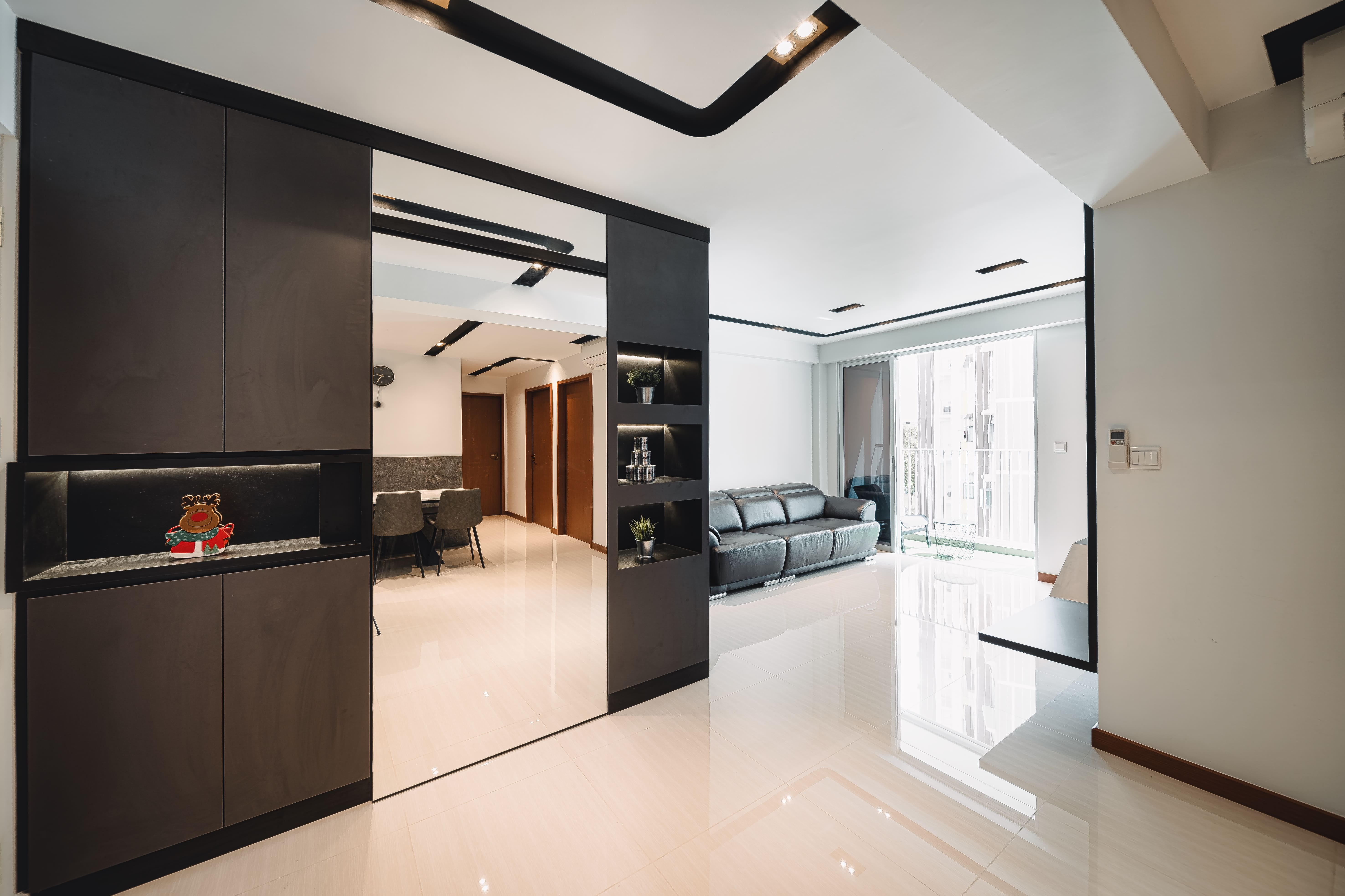 Entryway defined by clean-lined cabinetry and display niches, making a bold monochrome statement.