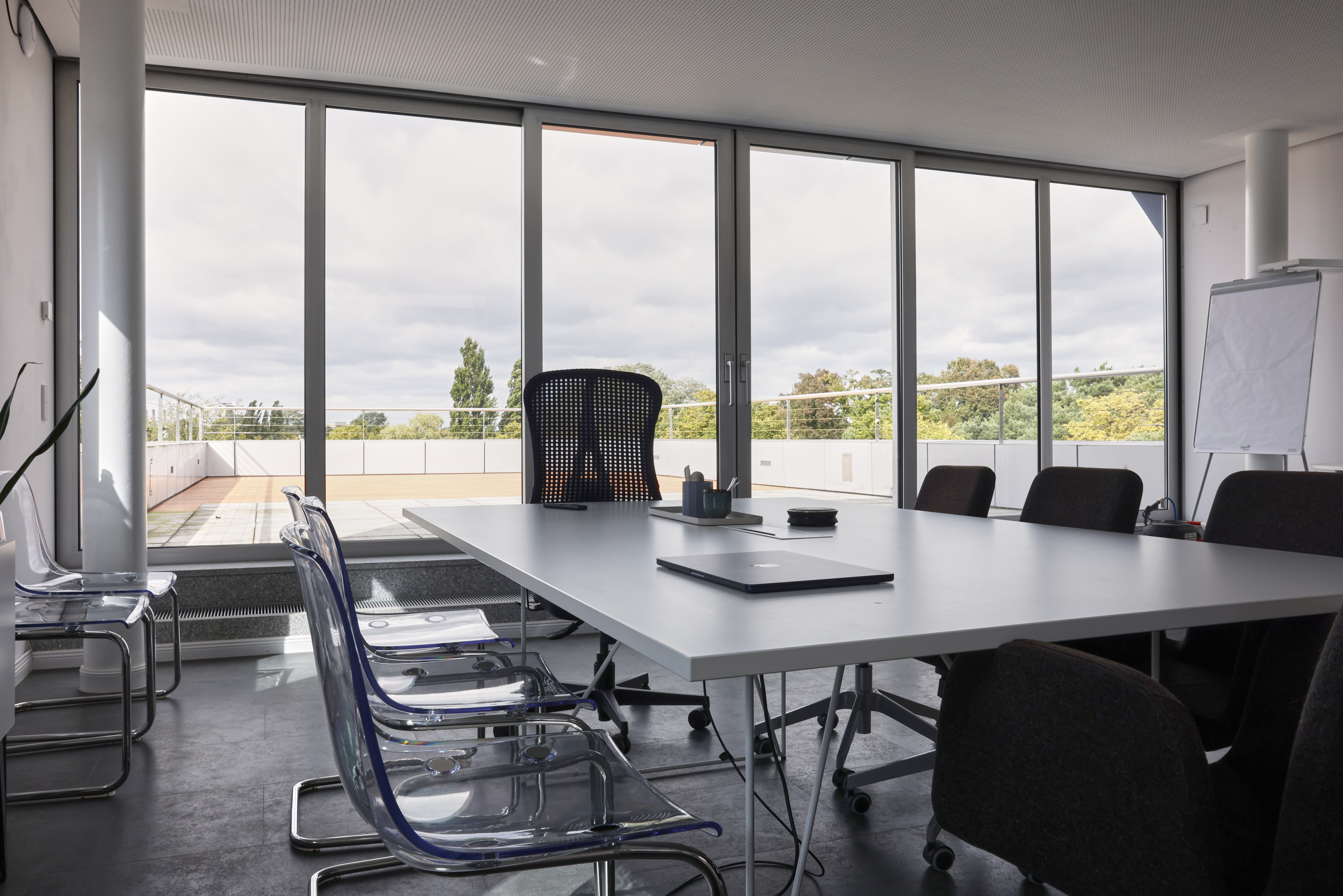 Pair of hands attaching camera lens to camera body in one of botspot's NEO scanners during the build-up process.