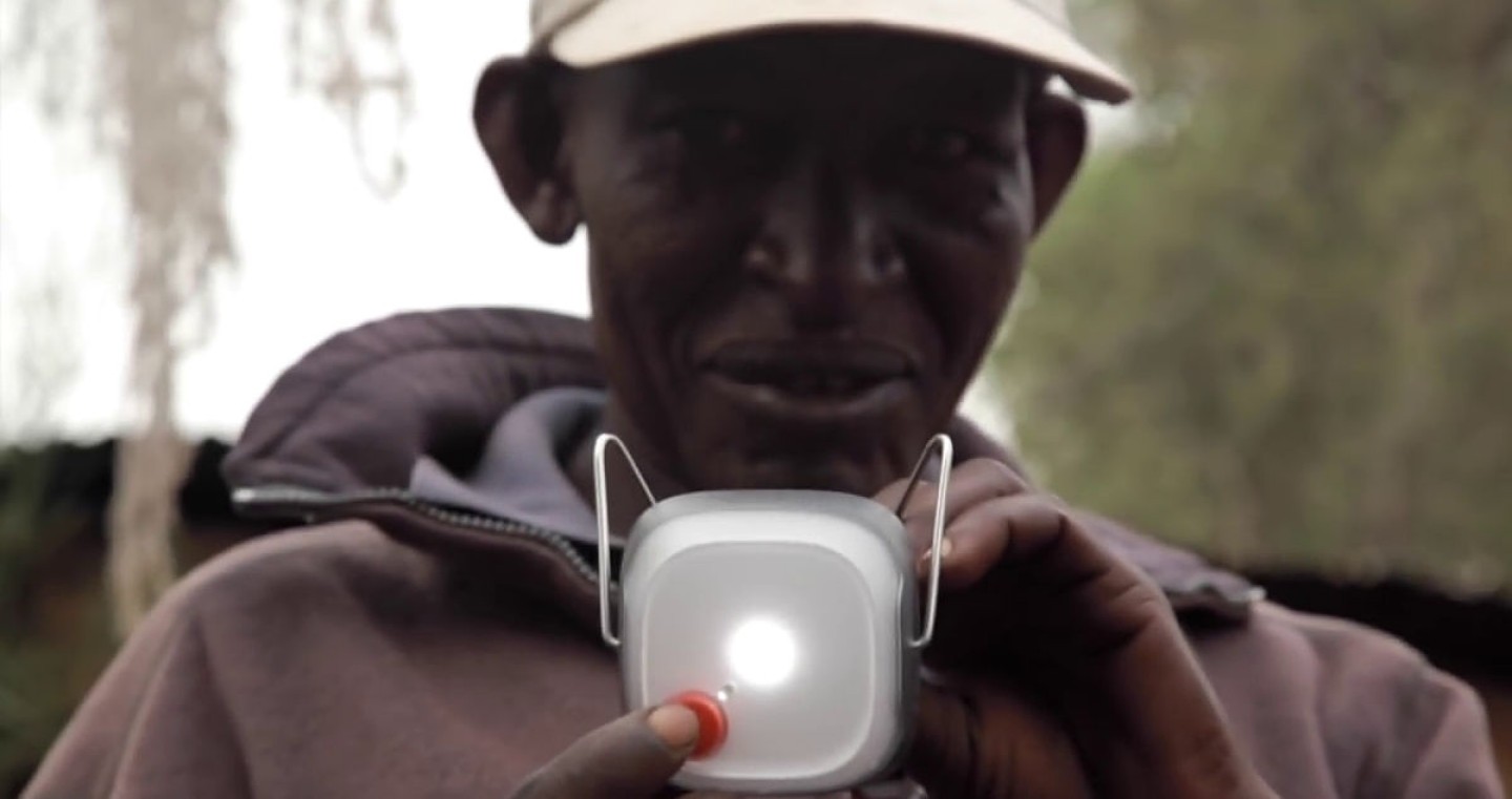 Man holding a portable solar light.