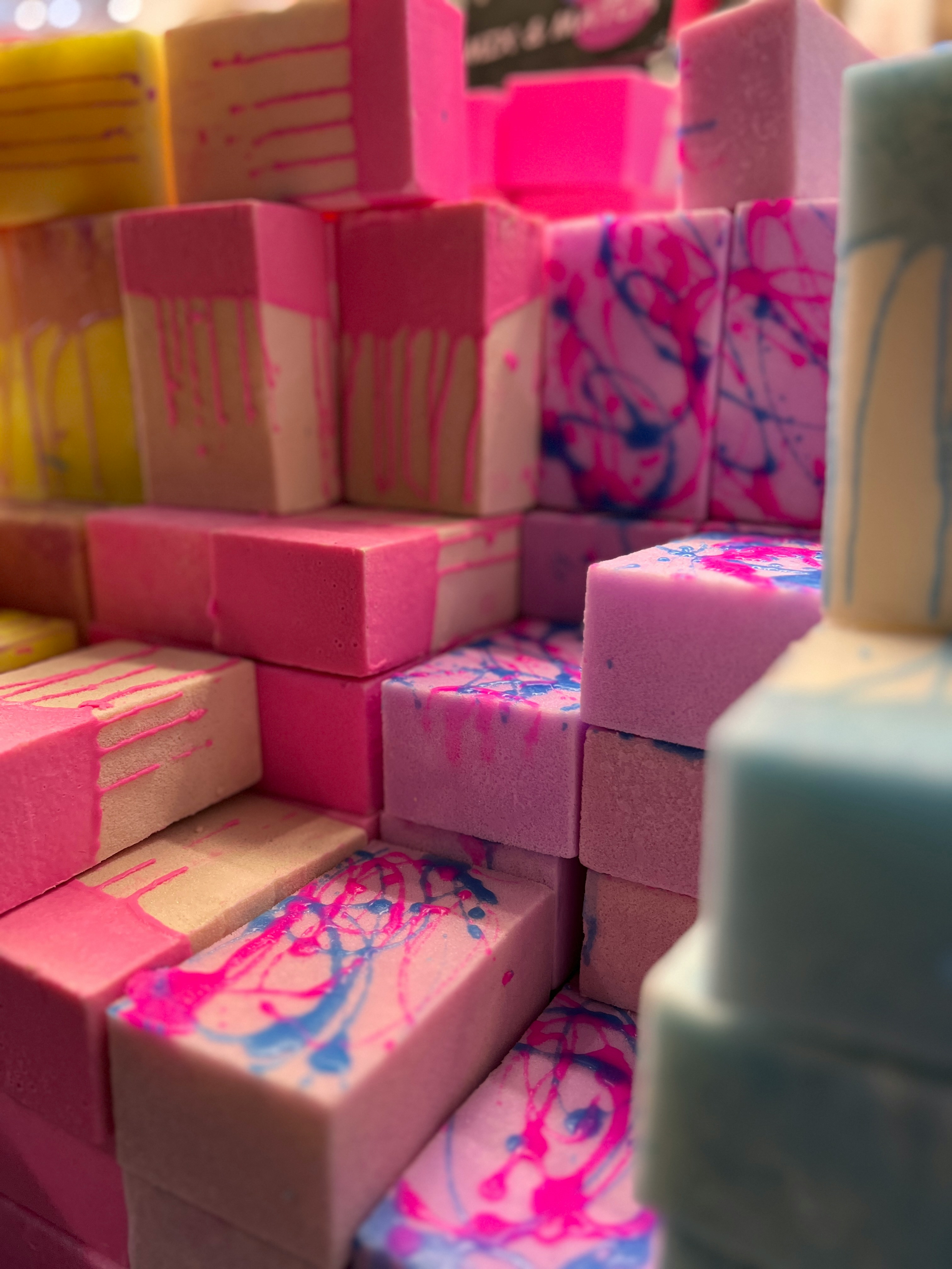 a close up of many different colored blocks of soap