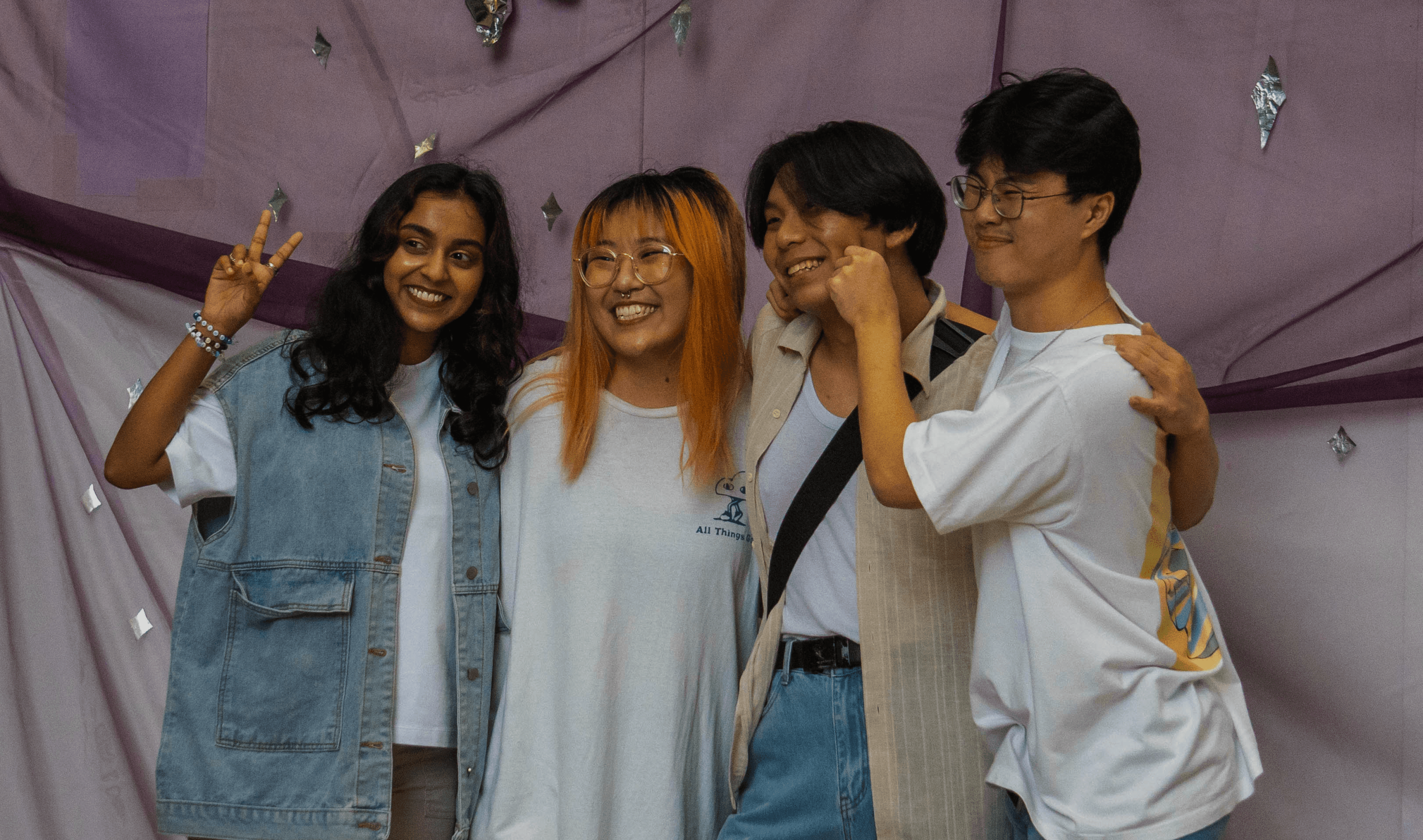 Ezekiel and friends of his gather for a photo together at a booth on his performance day