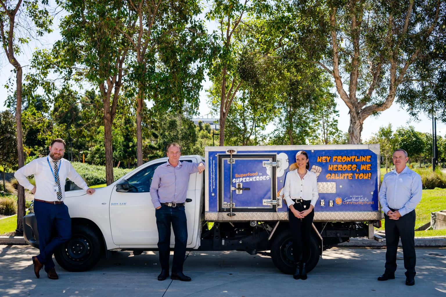 Craig & Hospital staff standing by the delivery truck for Superfood for Superheros