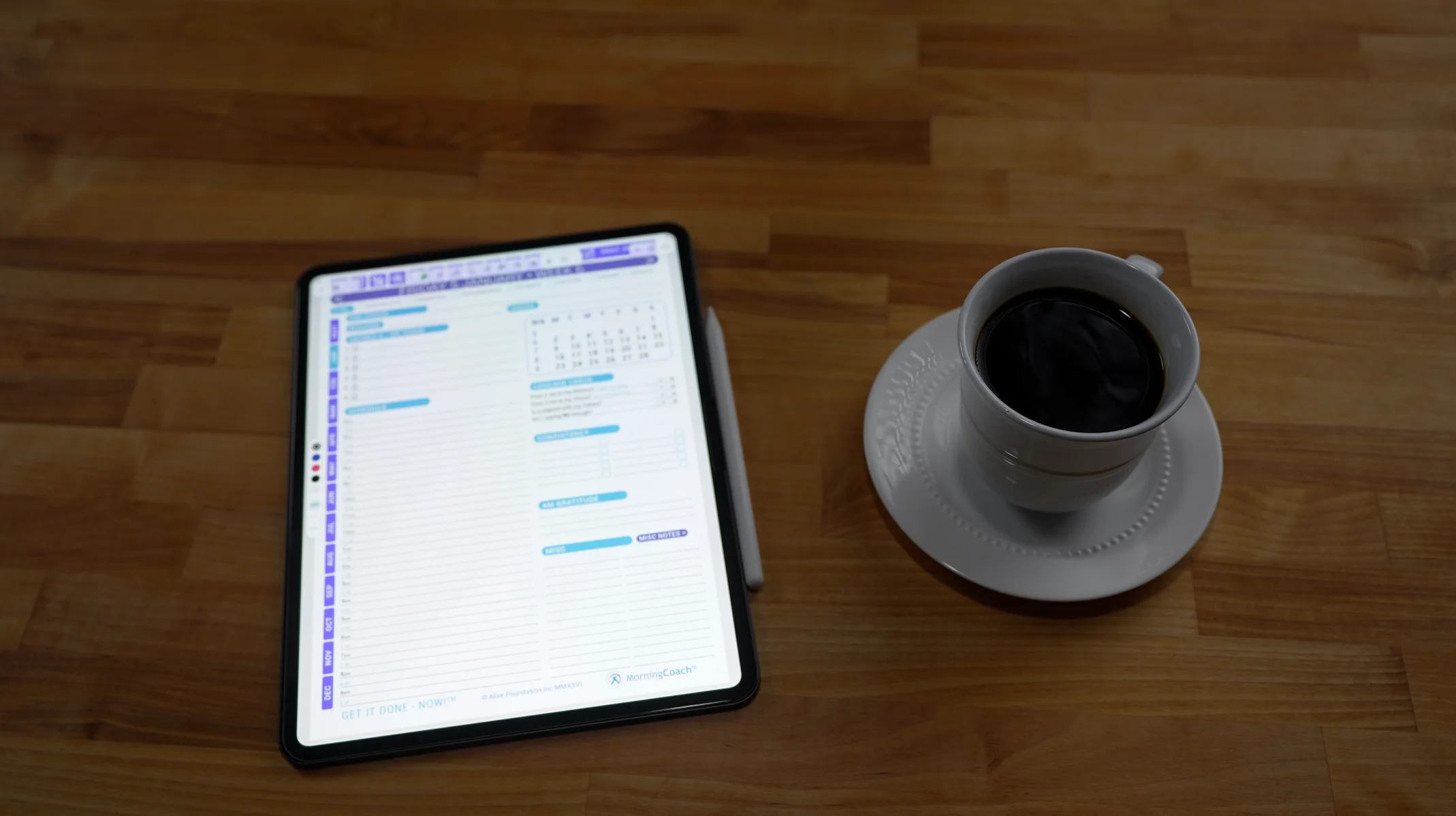 Get It Done — NOW! for Kindle Scribe planner beside a coffee cup
