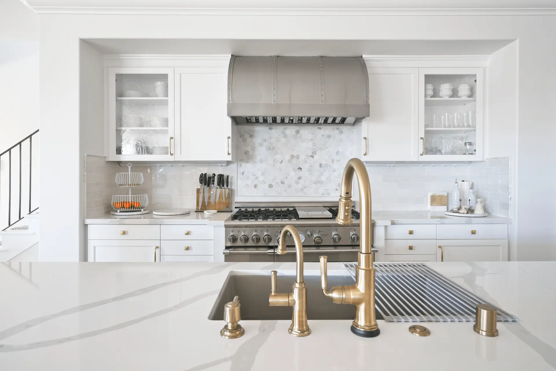 Wide view over the kitchen island towards the oven wall, showcasing the harmonious space distribution and contemporary design in the Ladera Ranch Remodel. Photo by Todd Huge.