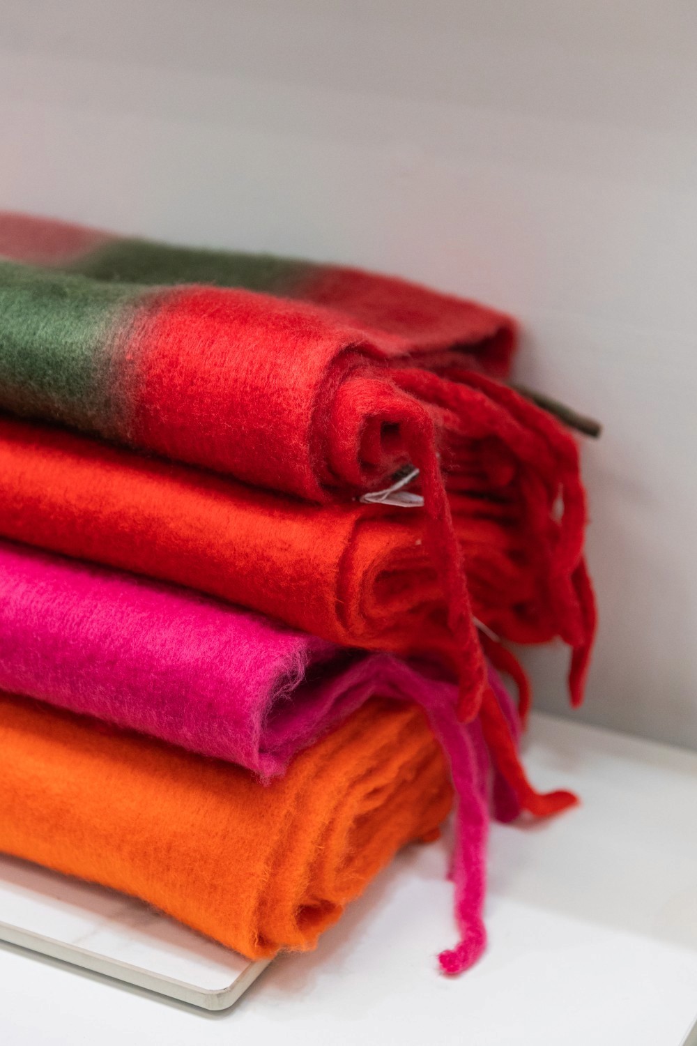 Modern white building with palm trees and courtyard.