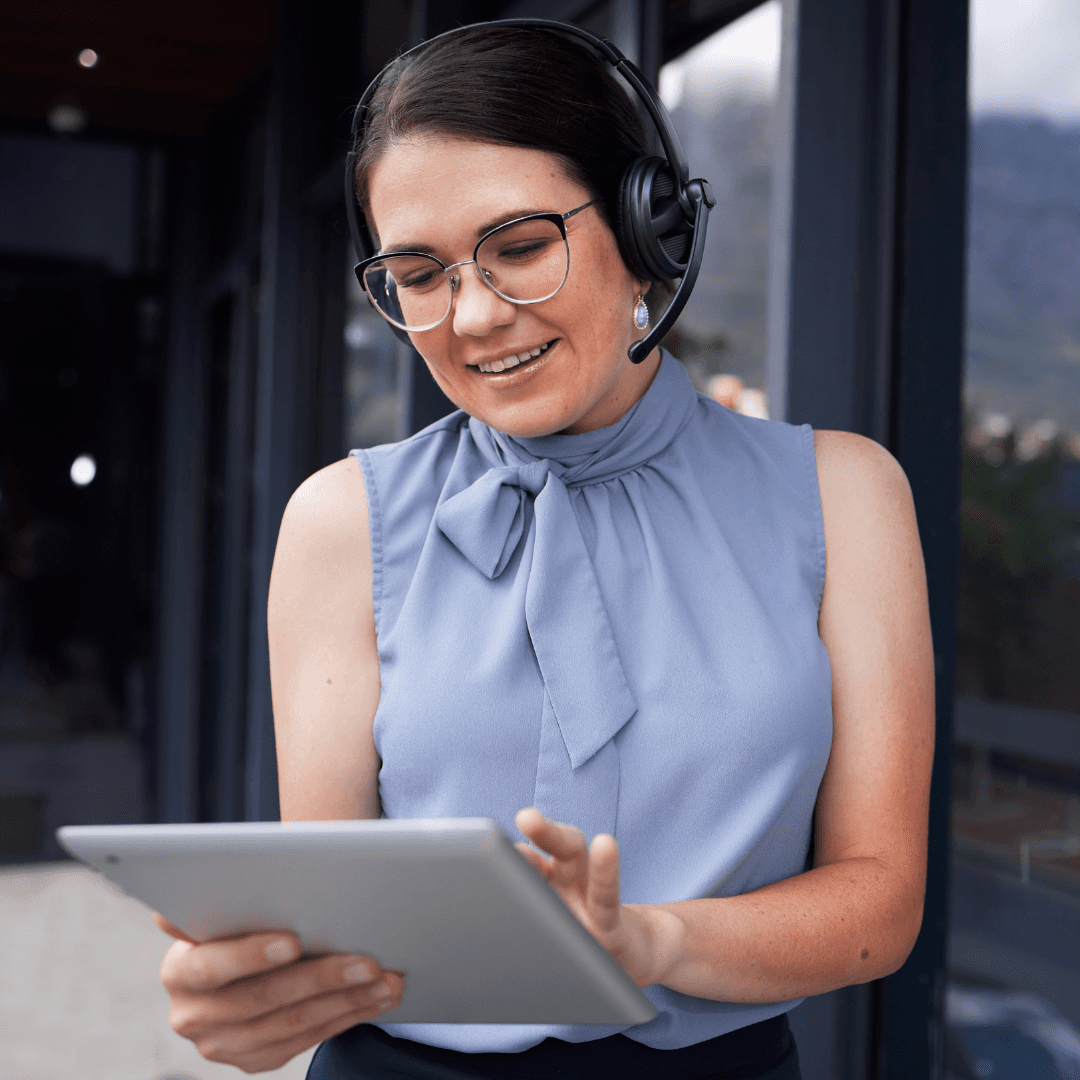 Professional Customer Service Assistant Talking to a customer on her headset whilst navigating her way through a touch screen 