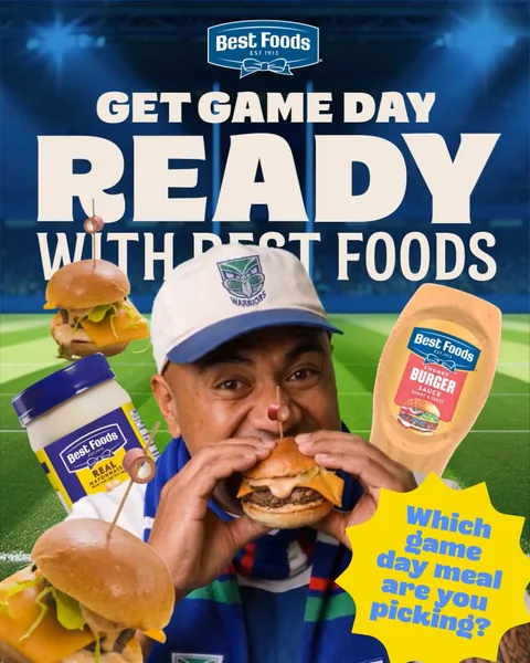 A man in a cap bites a burger, under the words “Get game day ready”