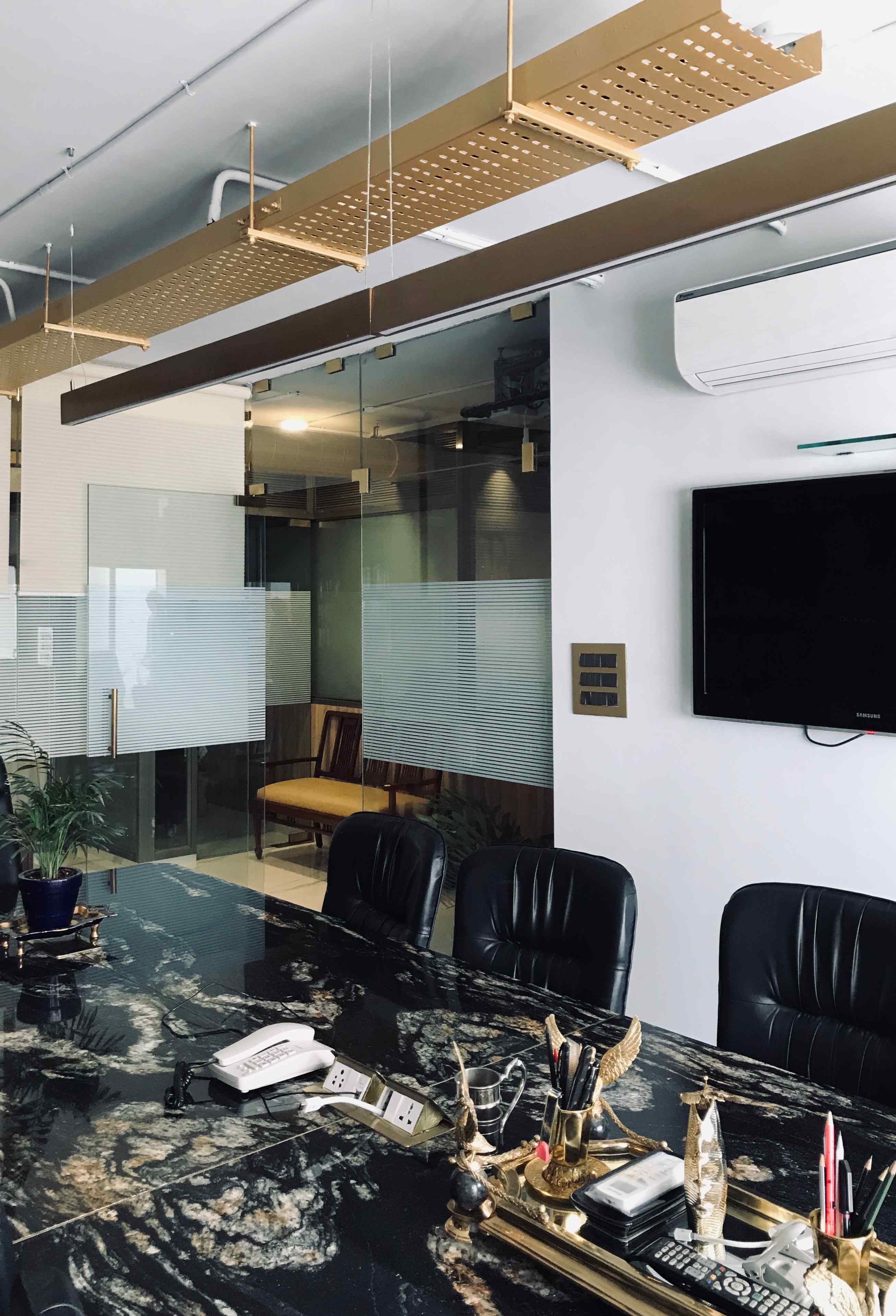 Nature-inspired preschool entrance with sculptural tree partitions and suspended green leaf ceiling panels.