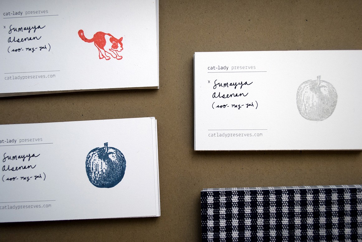 A photo of cards with different logos on them and some handwriting.