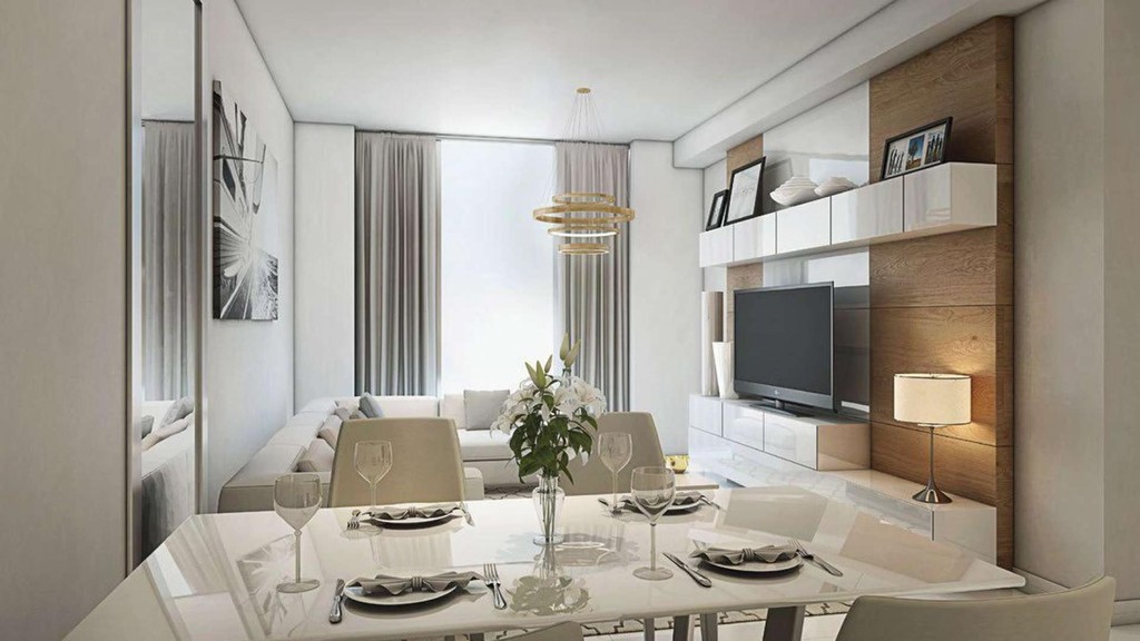 Contemporary dining area in Dragon Towers with sleek white furniture and a flat-screen television