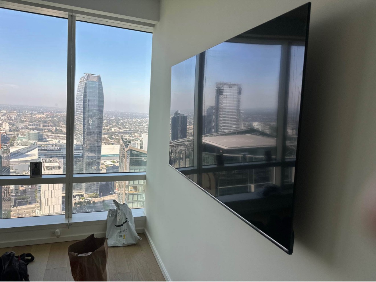 85-inch TV mounted using a swivel arm setup in a residential home in Houston, with clean wiring and a modern look.