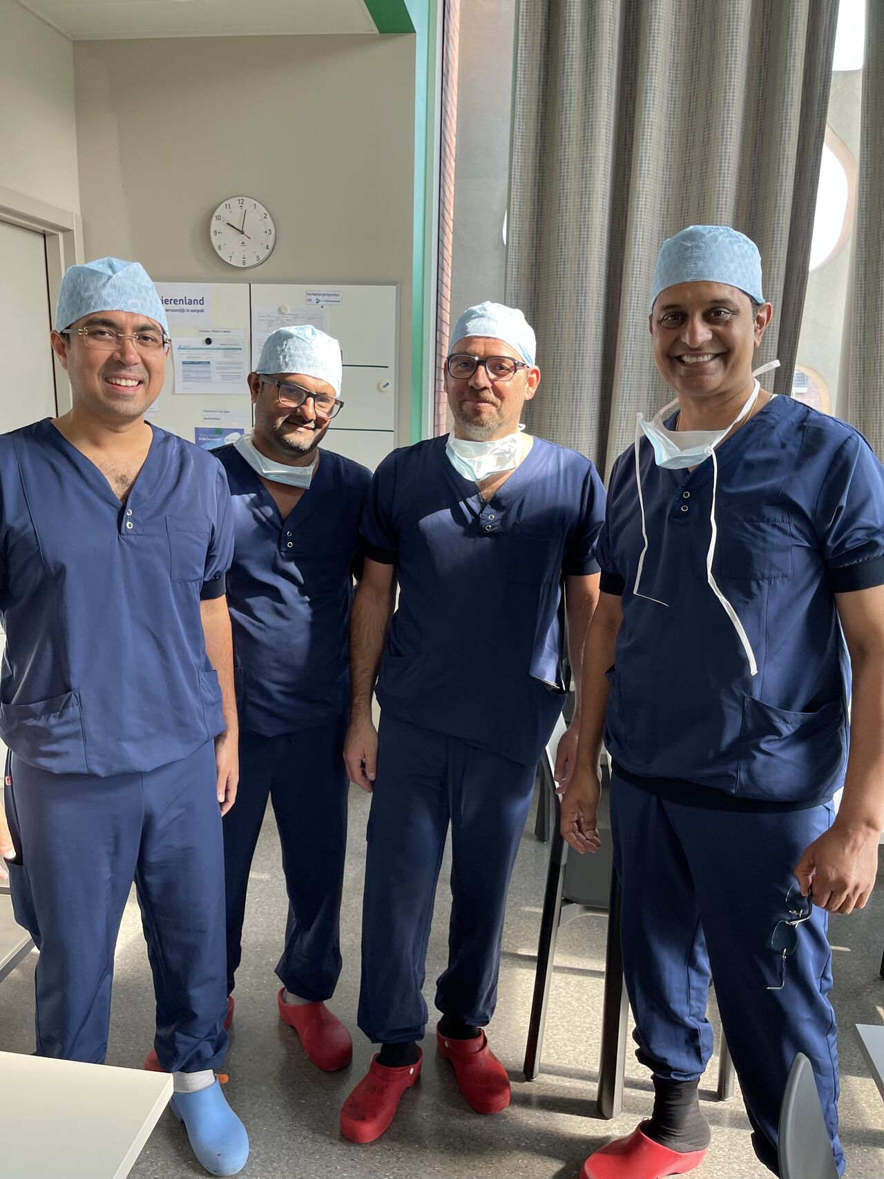 A futuristic white robot with an orange visor looking out over a city skyline