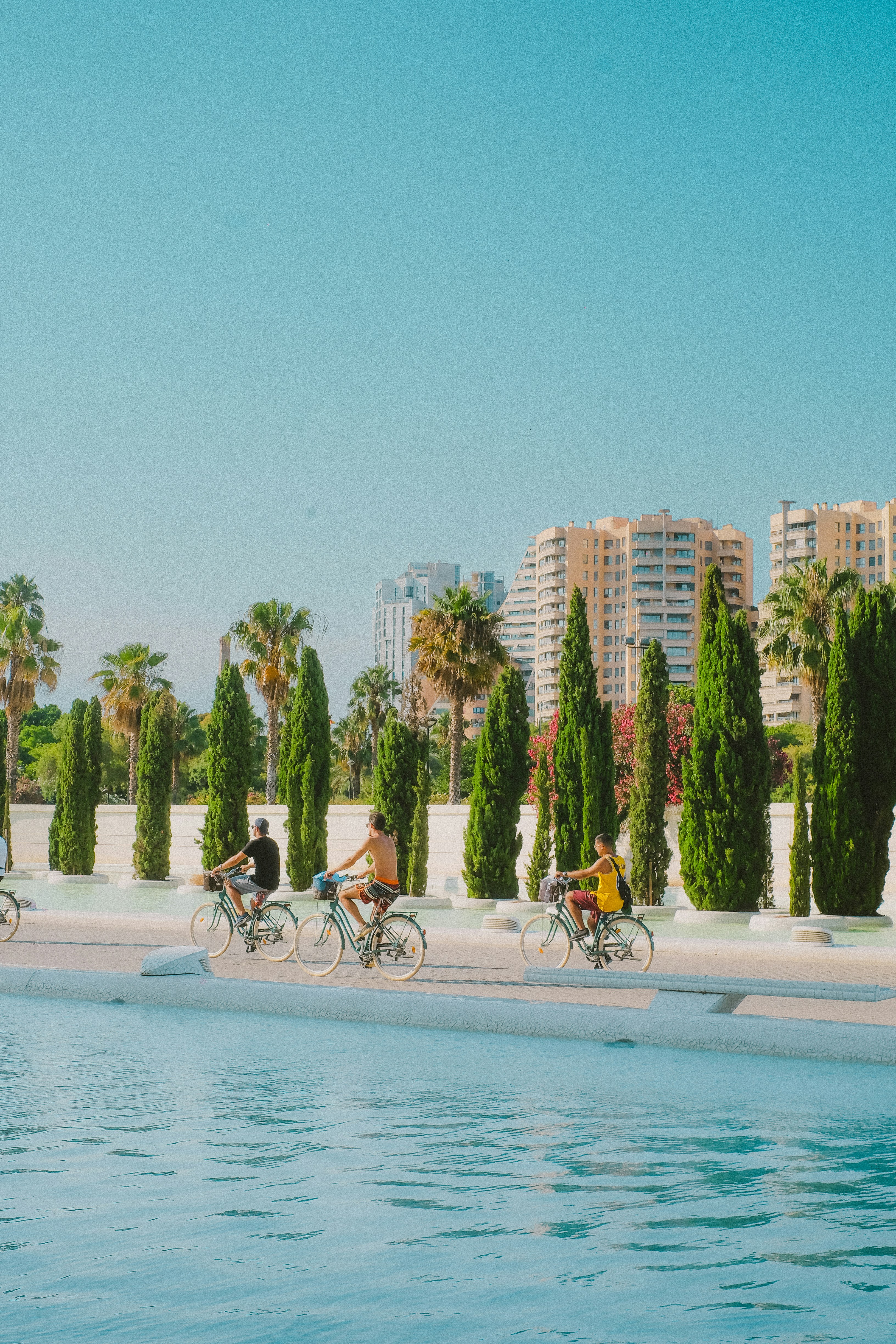 A group of people riding bikes on a beach
