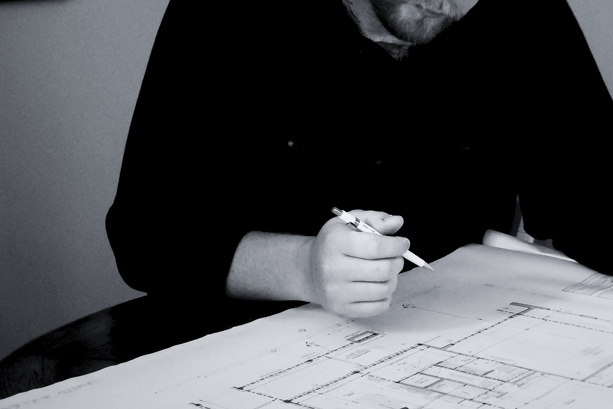 Architecture worker focosing on sketching a building.
