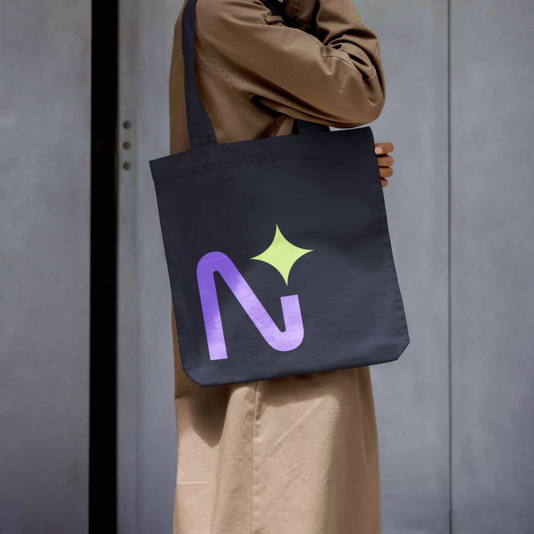 Dark navy tote bag with Neonify N logomark in purple gradient and lime sparkle