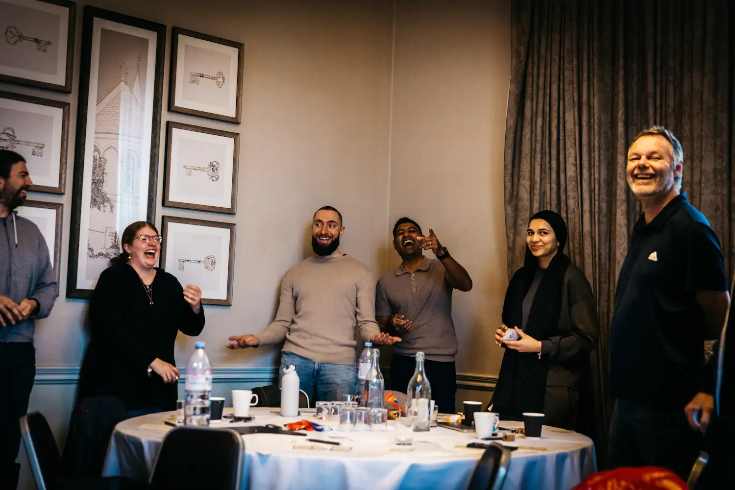 People having fun at a table with food.