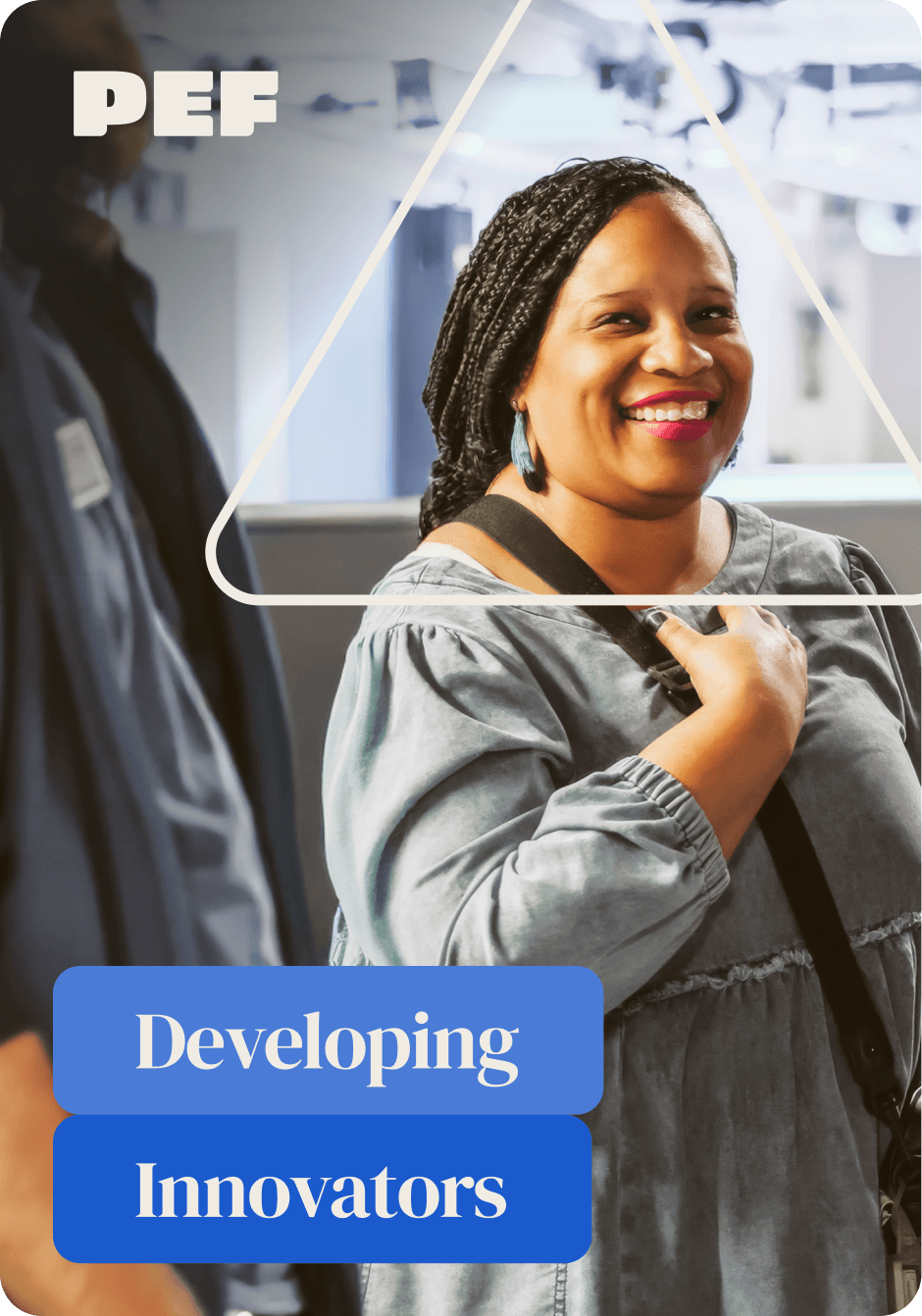 Femail teacher standing in a group of fellow teachers, smiling at the camera. 