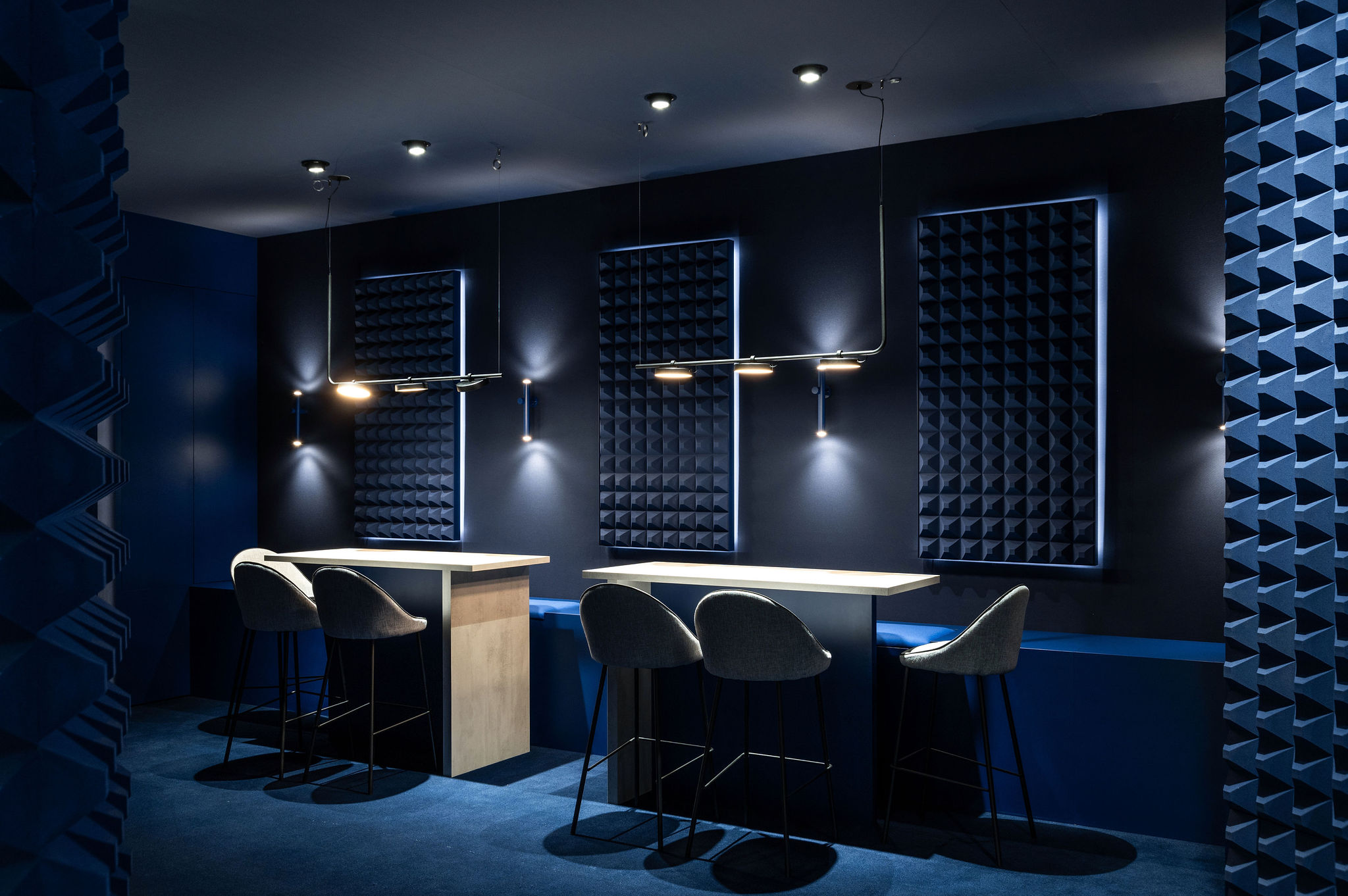 Meeting and cosy area of the H. Moser & Cie design retail and creative  concept booth for the Watches and Wonders fair 2024 