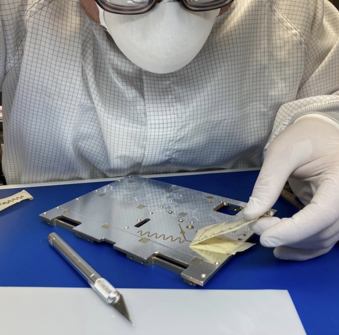 engineer applying artwork to panel