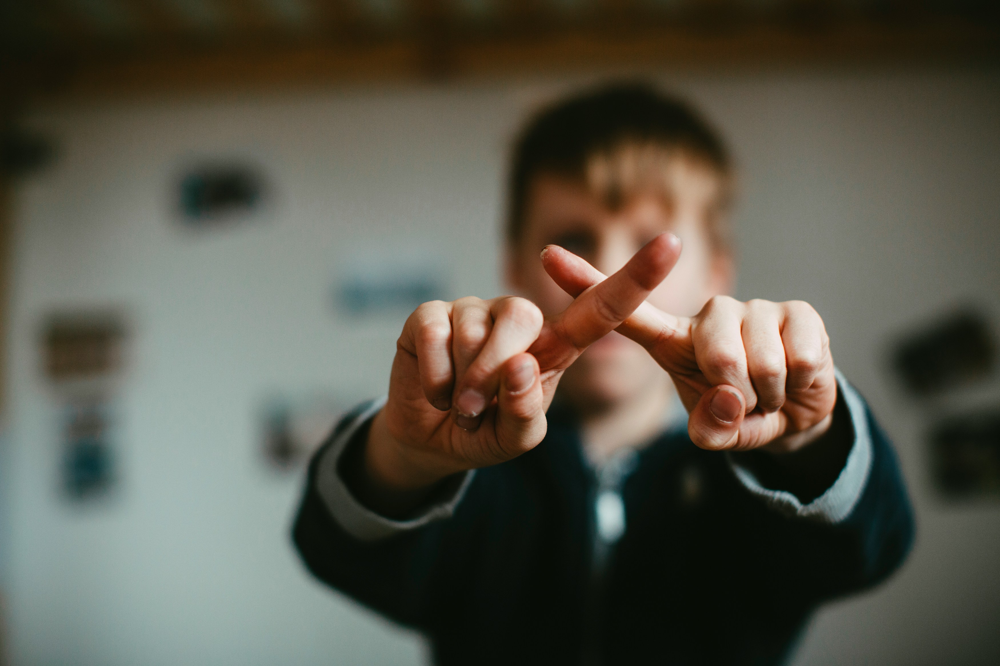 man in black and white jacket doing peace sign