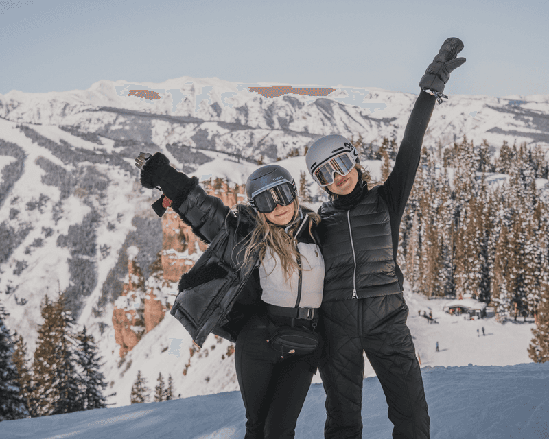 Two skiers celebrating their day on the mountain