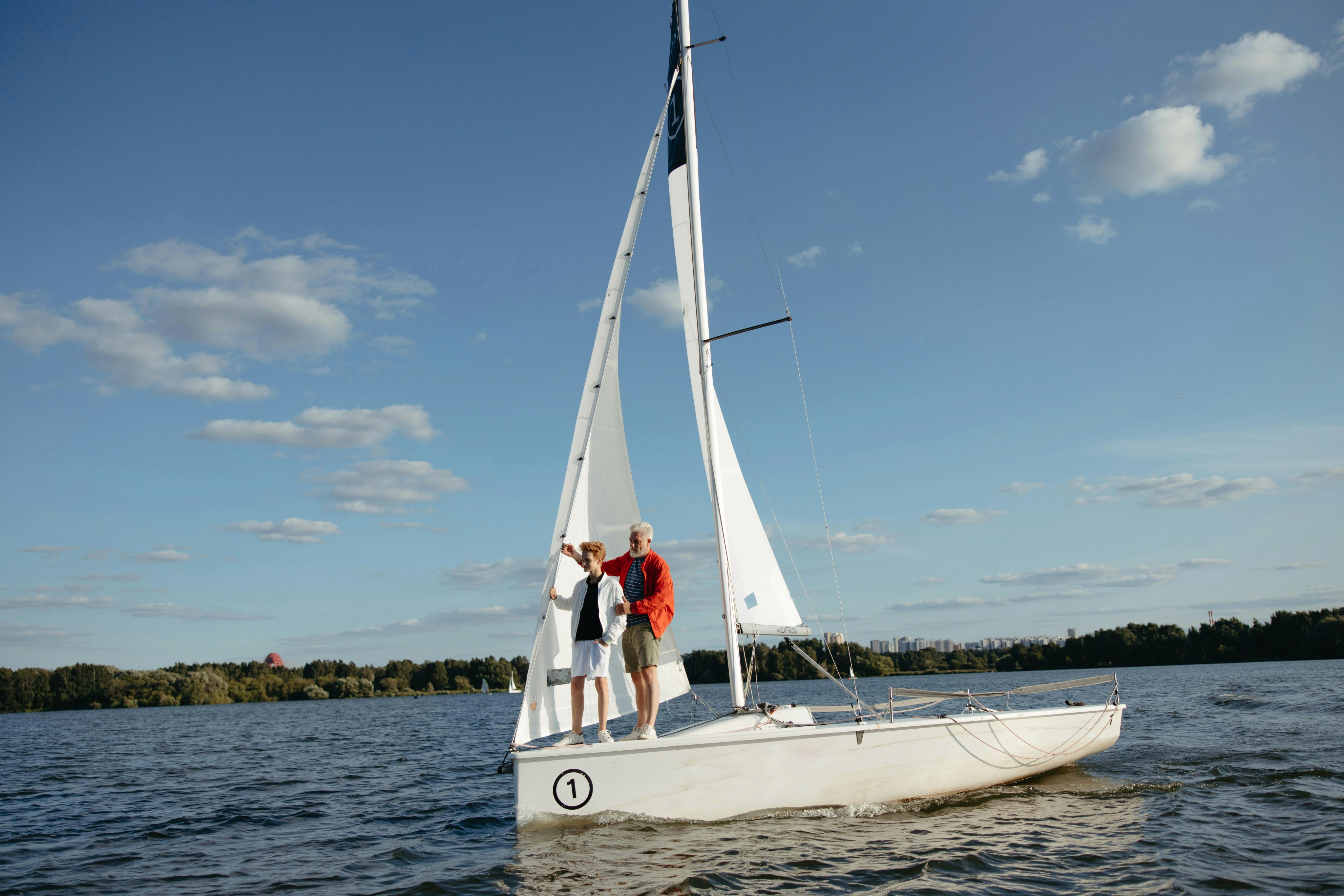 Grandfather and grandson on a sail boat