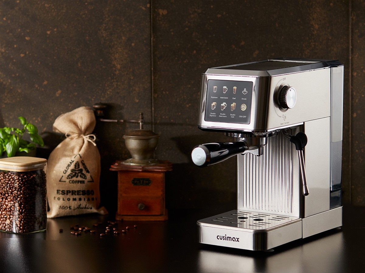 A modern espresso machine with a digital touchscreen is displayed on a dark kitchen counter, surrounded by a wooden cutting board, a small plant, a jar of coffee beans, a burlap sack labeled "ESPRESSO," and a vintage coffee grinder, creating a cozy and inviting coffee-making setup.