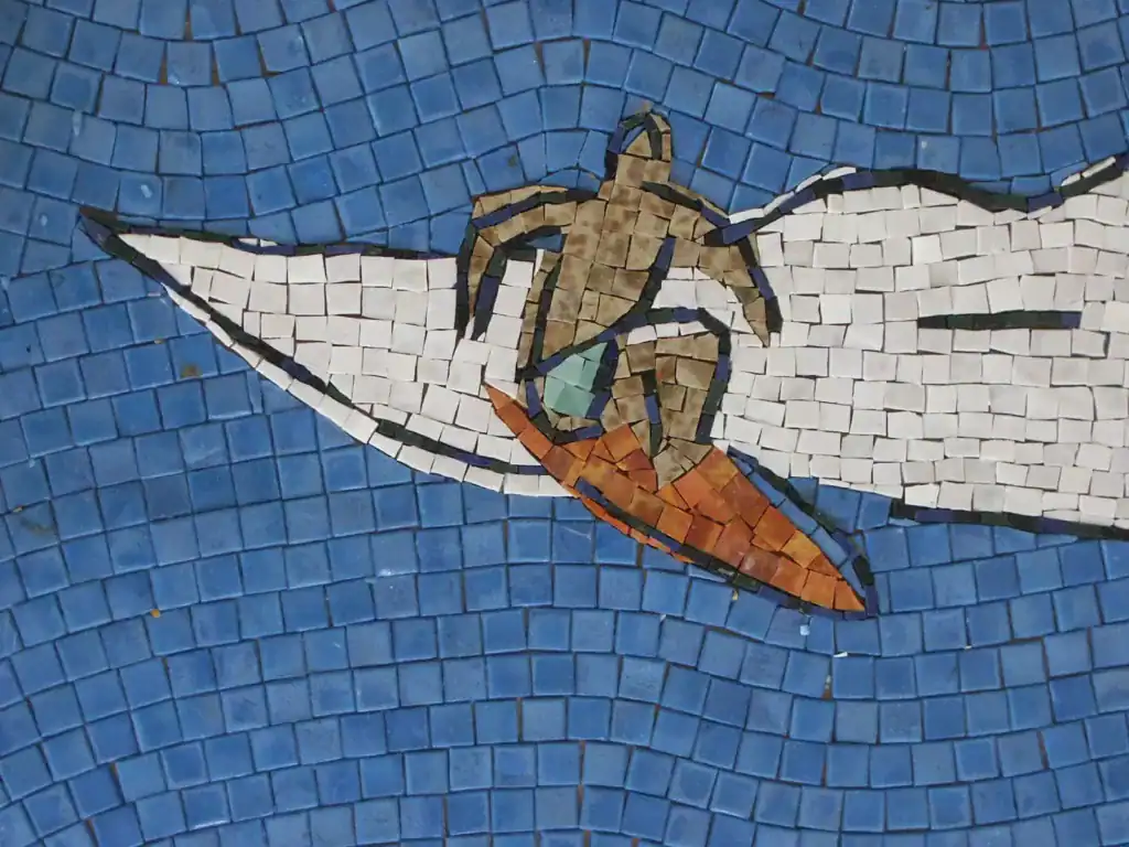 Colorful mosaic mural of a surfer turtle at San Diego Airport.