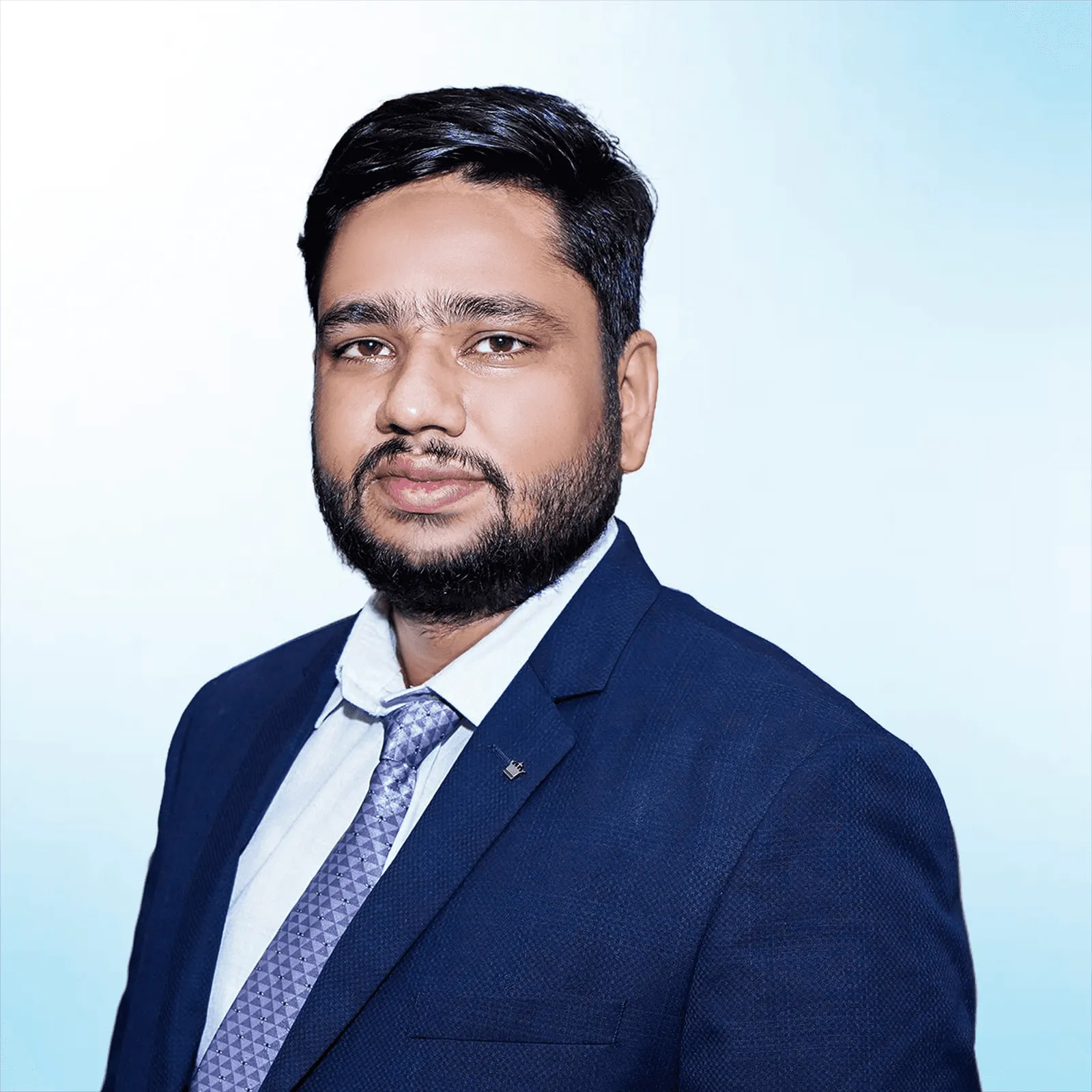 Man with a beard in a navy suit and white shirt