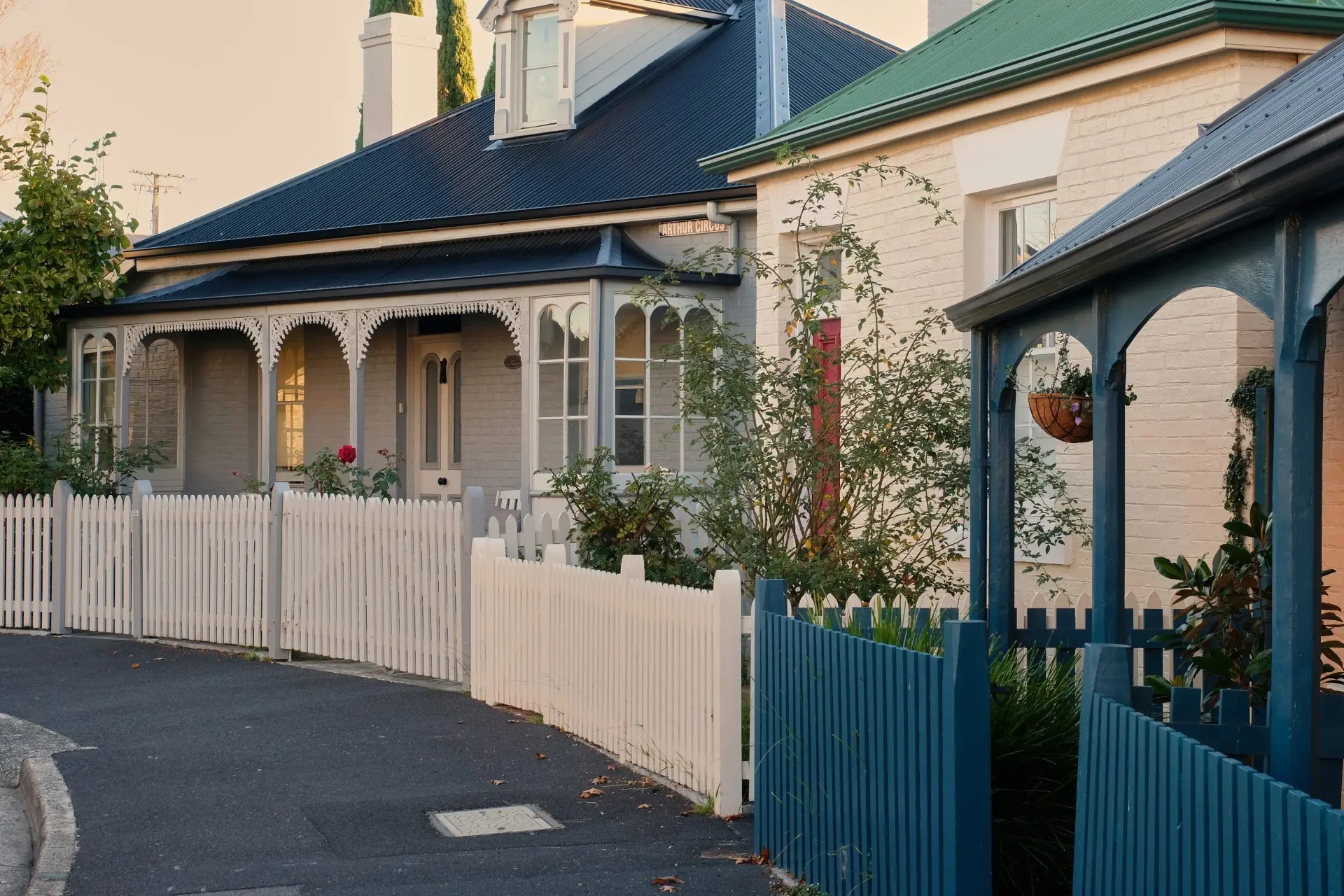 Victorian homes with white picket fences.
