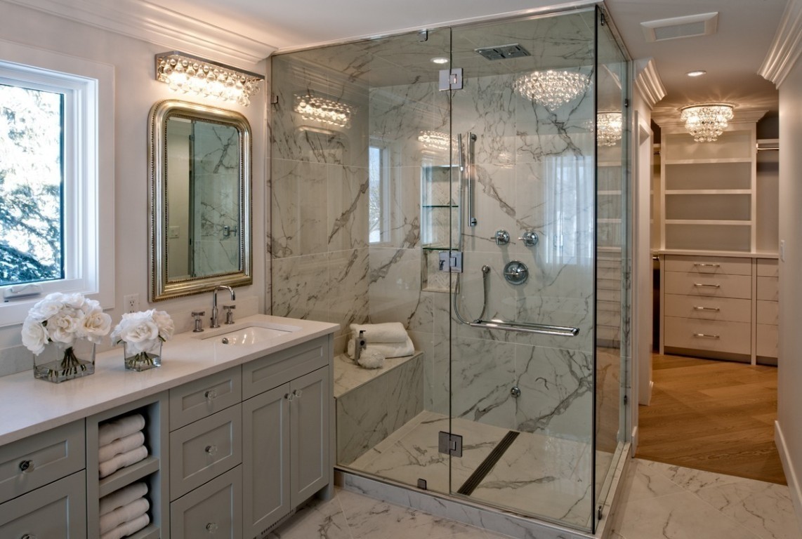 Image of Luxurious primary ensuite bathroom with marble shower, double vanity, and spacious walk-in closet by KHD Homes.
