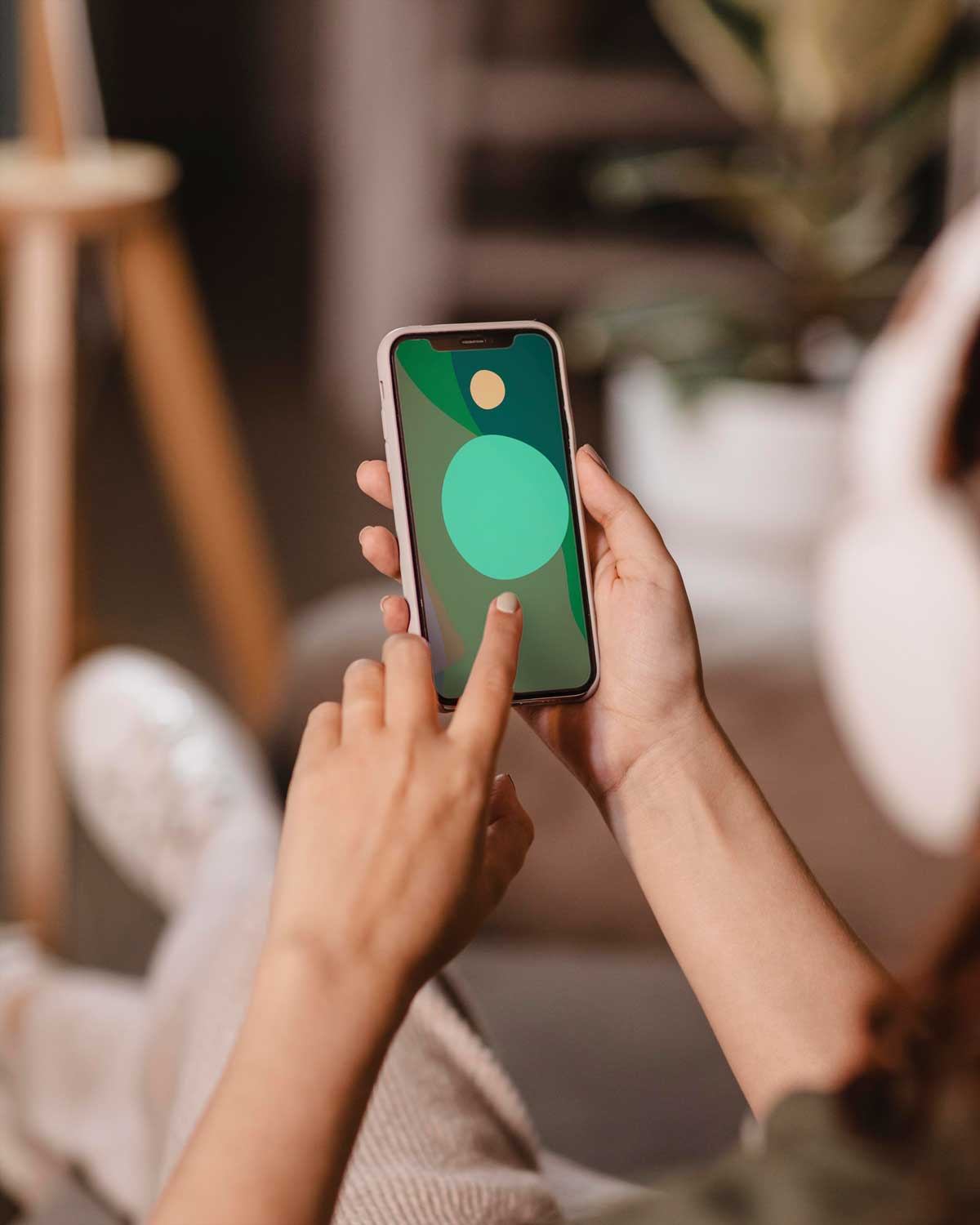 two hands holding an iPhone with the apple logo clearly displayed