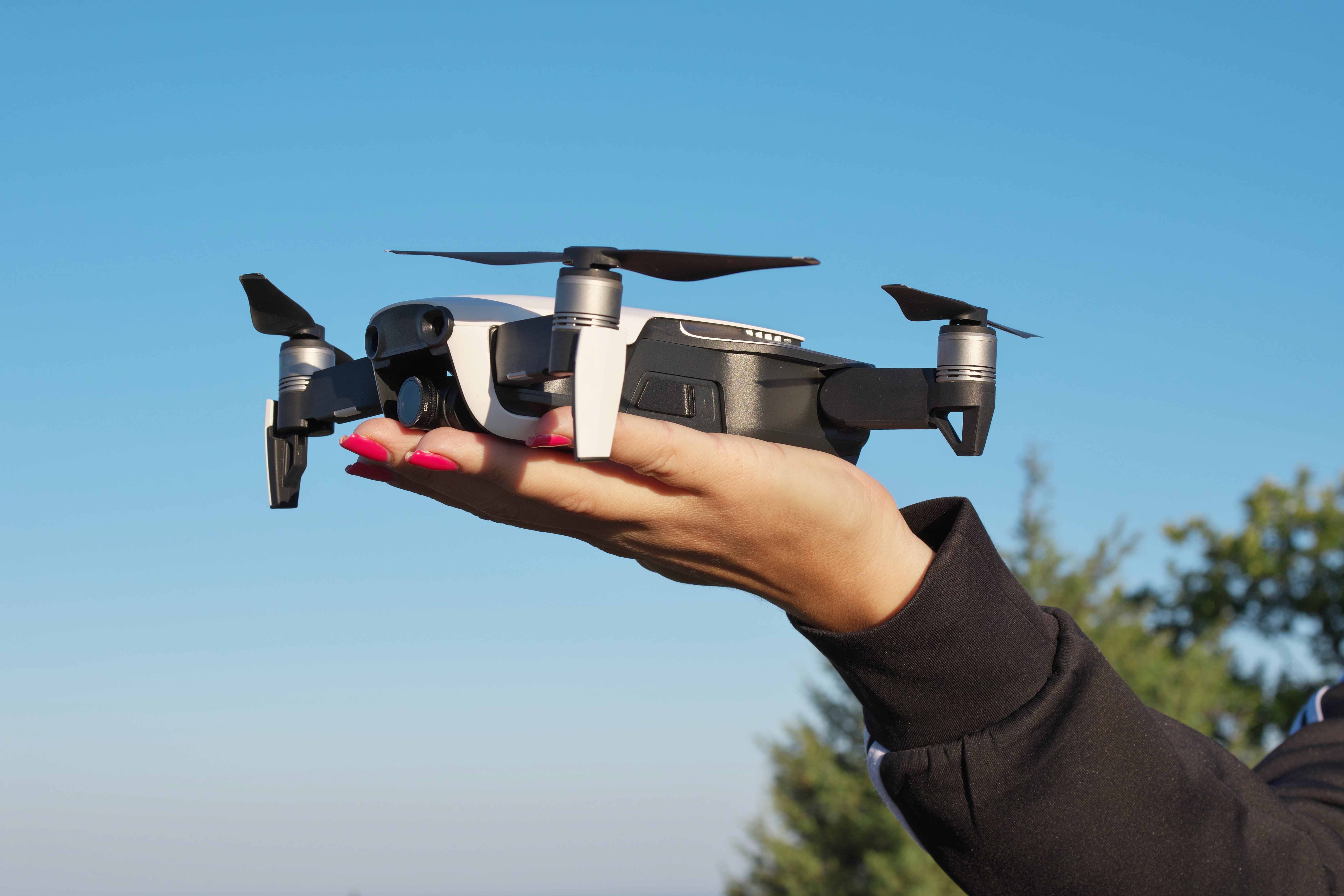 Person holding a drone ready for flight, symbolizing opportunities and innovation in building a career in drone photography.