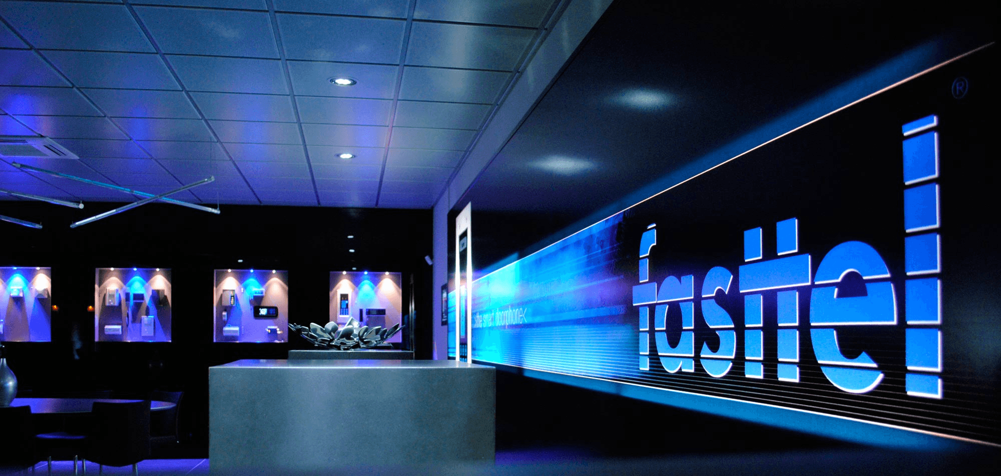 Blue "Fastel" logo on dark background