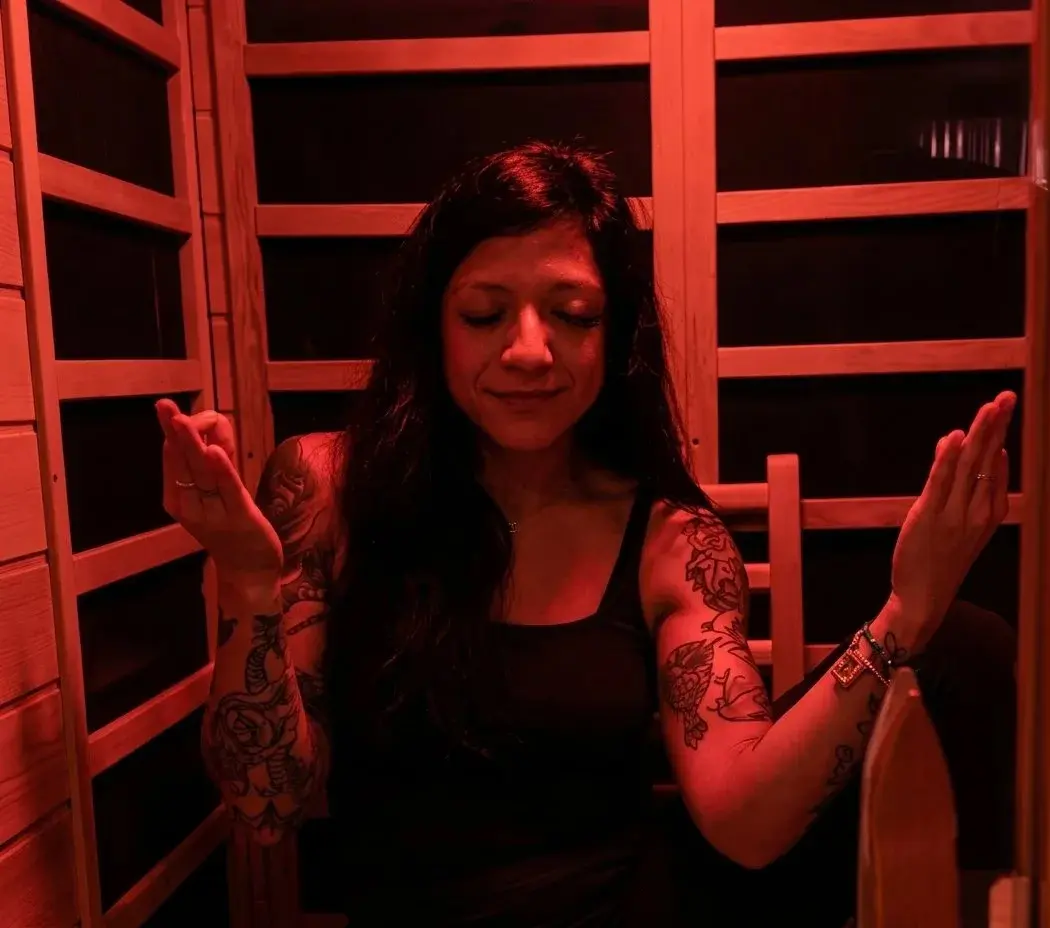 Big Tex Gym front desk staff member meditating inside the on-site infrared sauna
