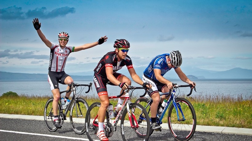 Cyclist racing under a blue sky