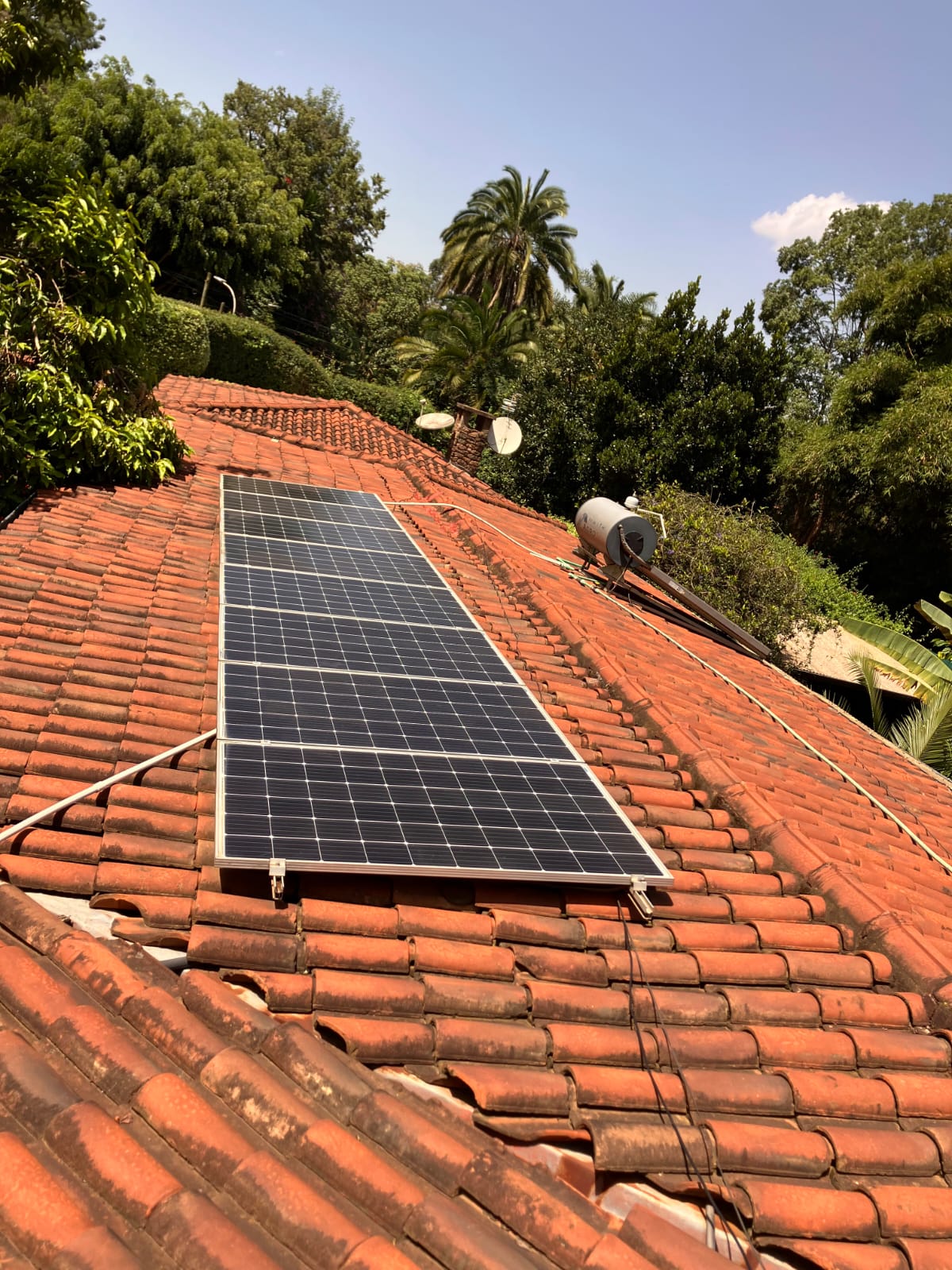 Solar panel on a tiled roof in a residential area.