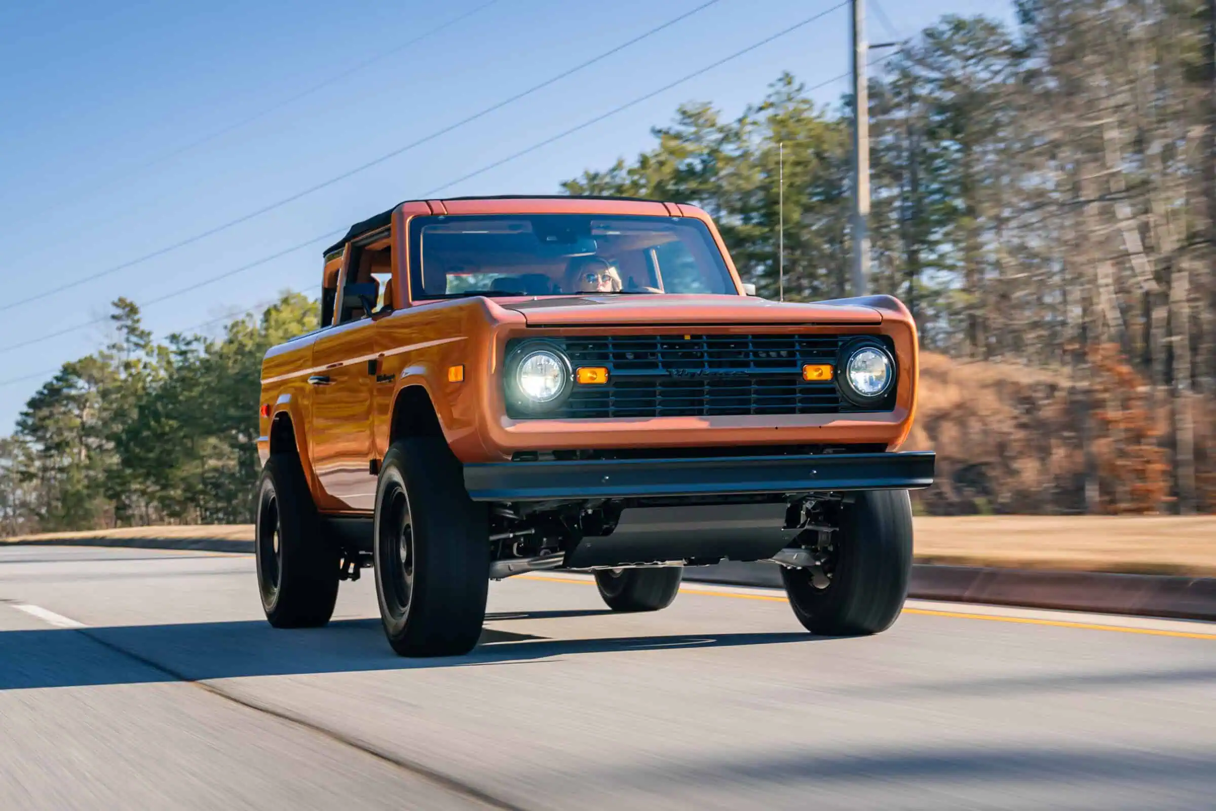 Man with camera near lake and mountains