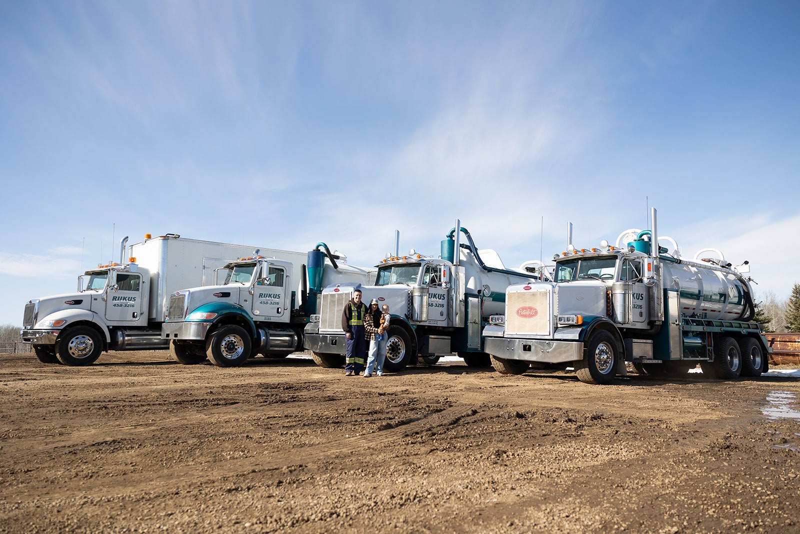 Rukus Liquid Waste Removal fleet of vacuum trucks and septic service vehicles parked on site in Calahoo, Alberta, serving Edmonton and surrounding areas with professional liquid waste management and septic pumping services.