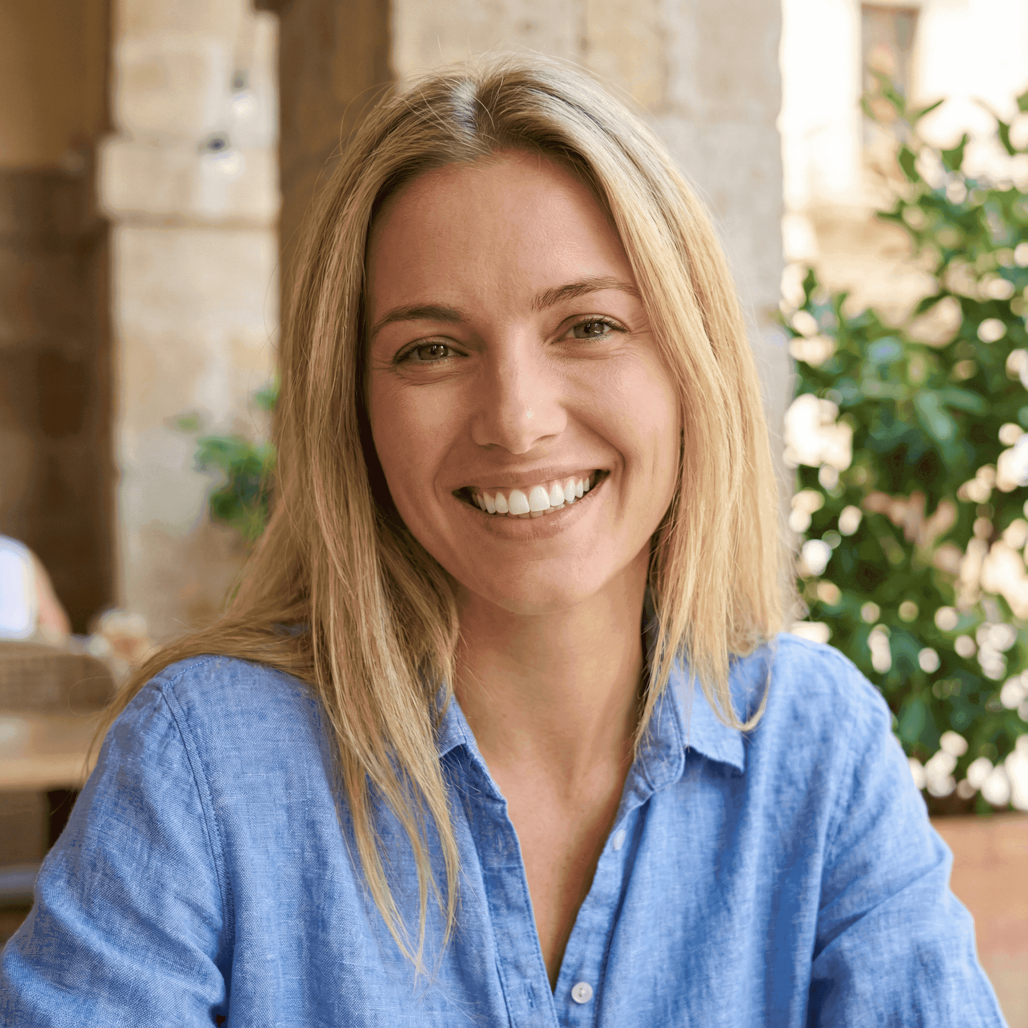 Invisalign in Dubai with a woman smiling confidently, holding her clear aligners, highlighting discreet and effective treatment.