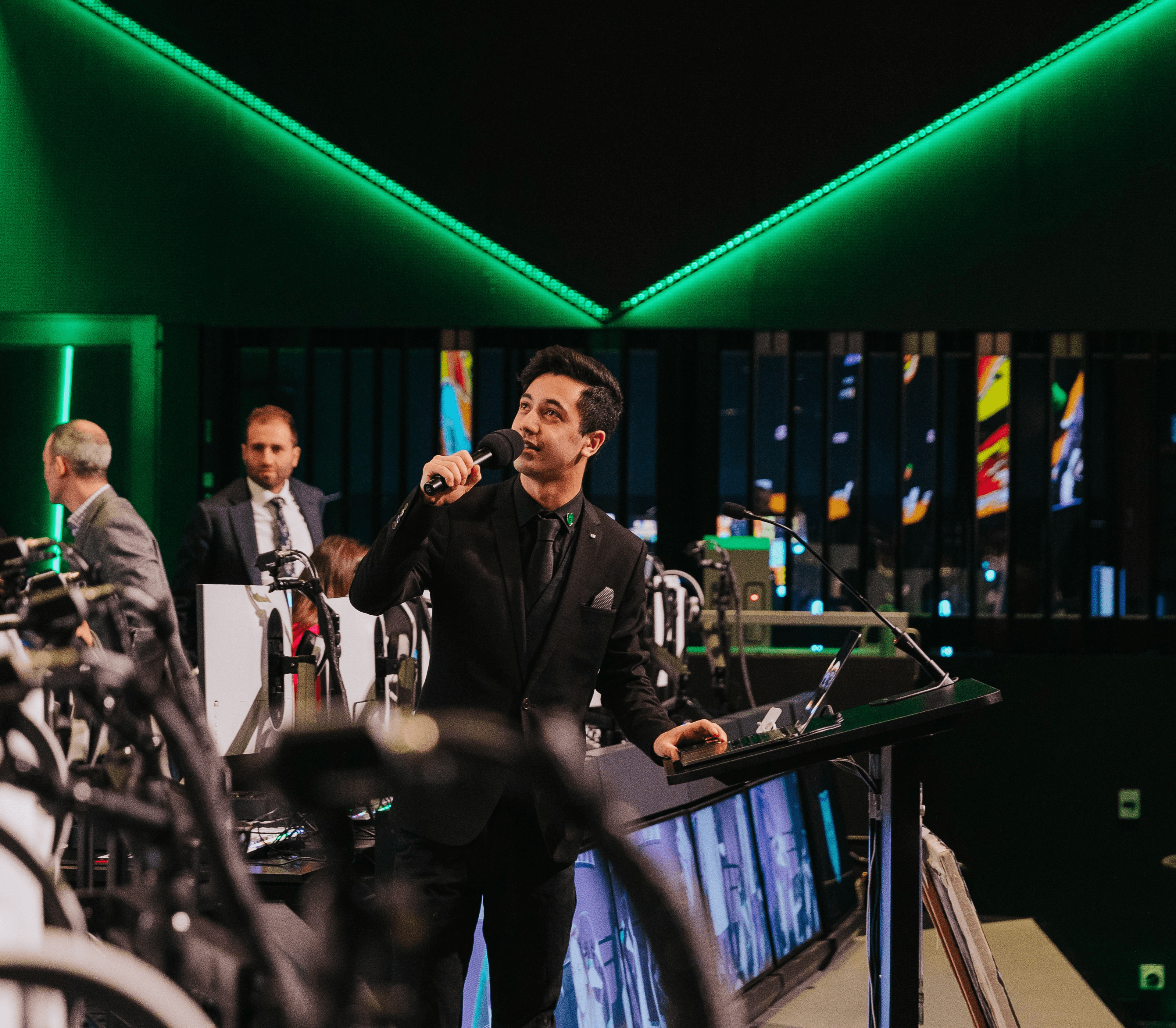 Man on Stage at Fortress with a microphone at a Corporate Function Conference