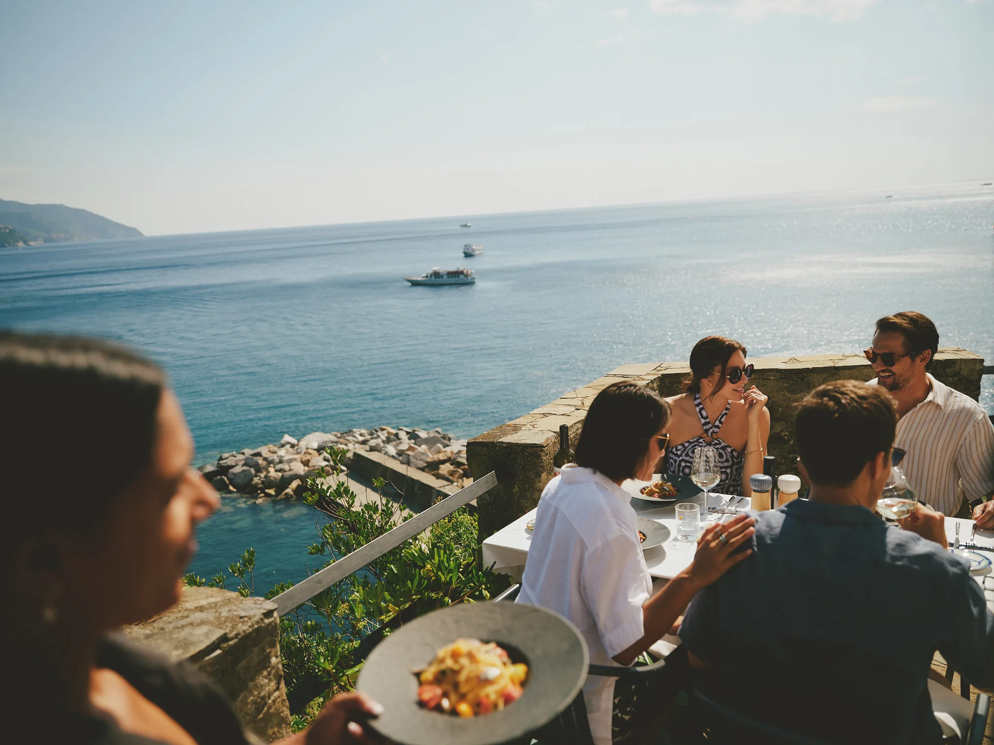 cliffside lunch table above the sea — lifestyle photography by Tom Kubik