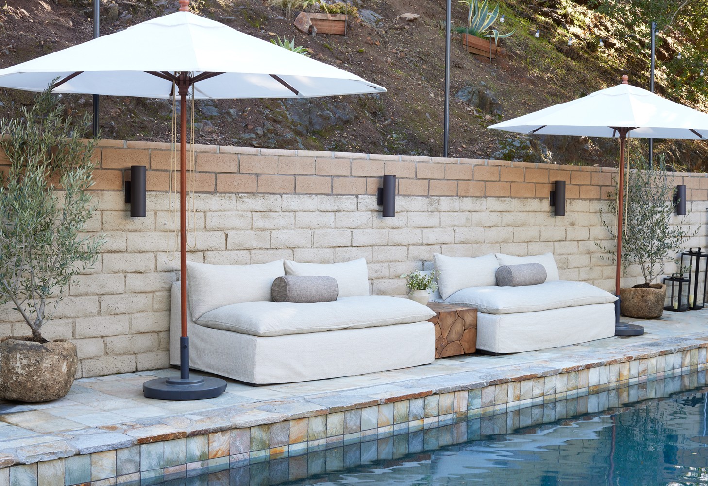 Outdoor pool-side  space design, raw wood tones, lush greenery