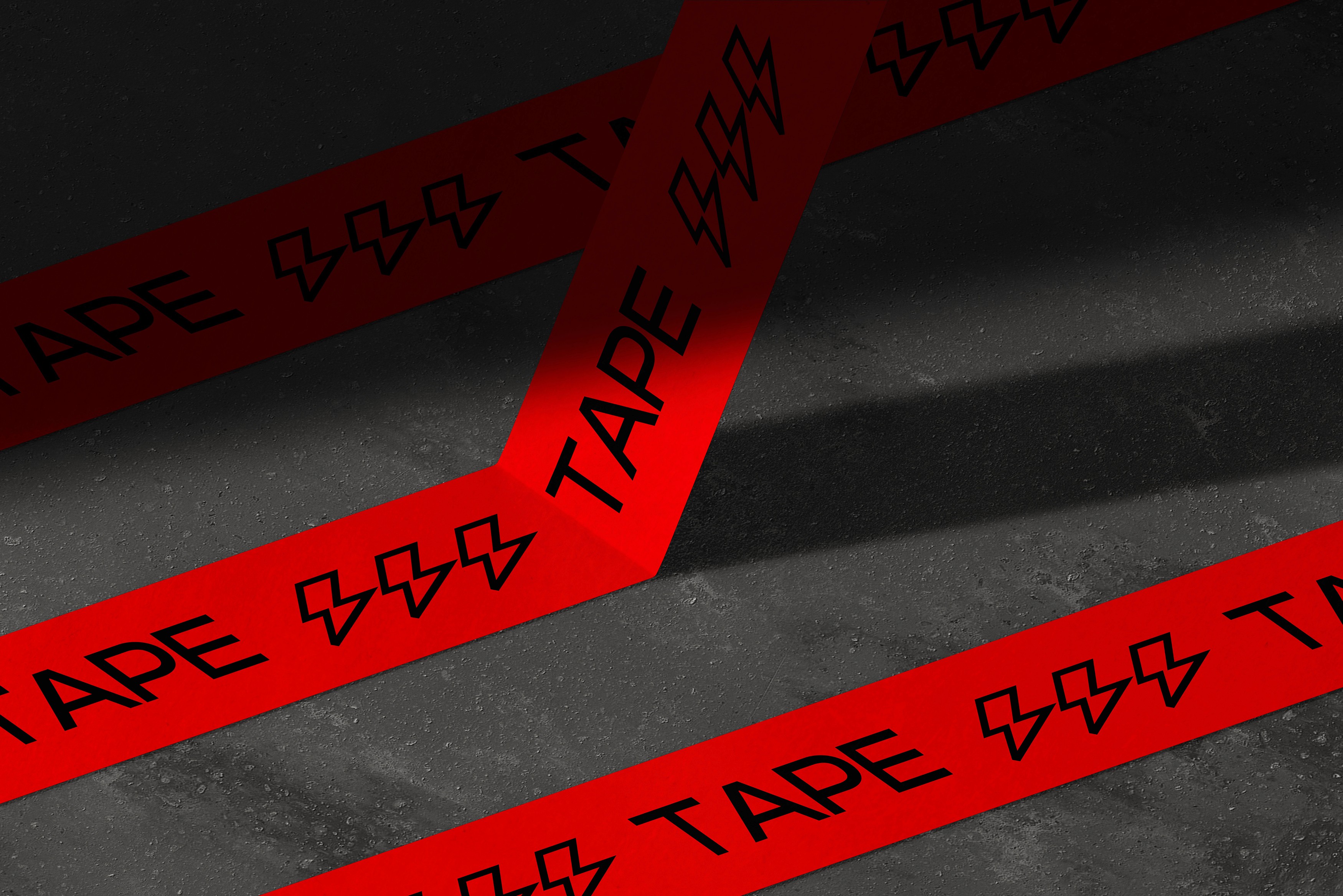 Red printed tape with black typography arranged diagonally across concrete steps