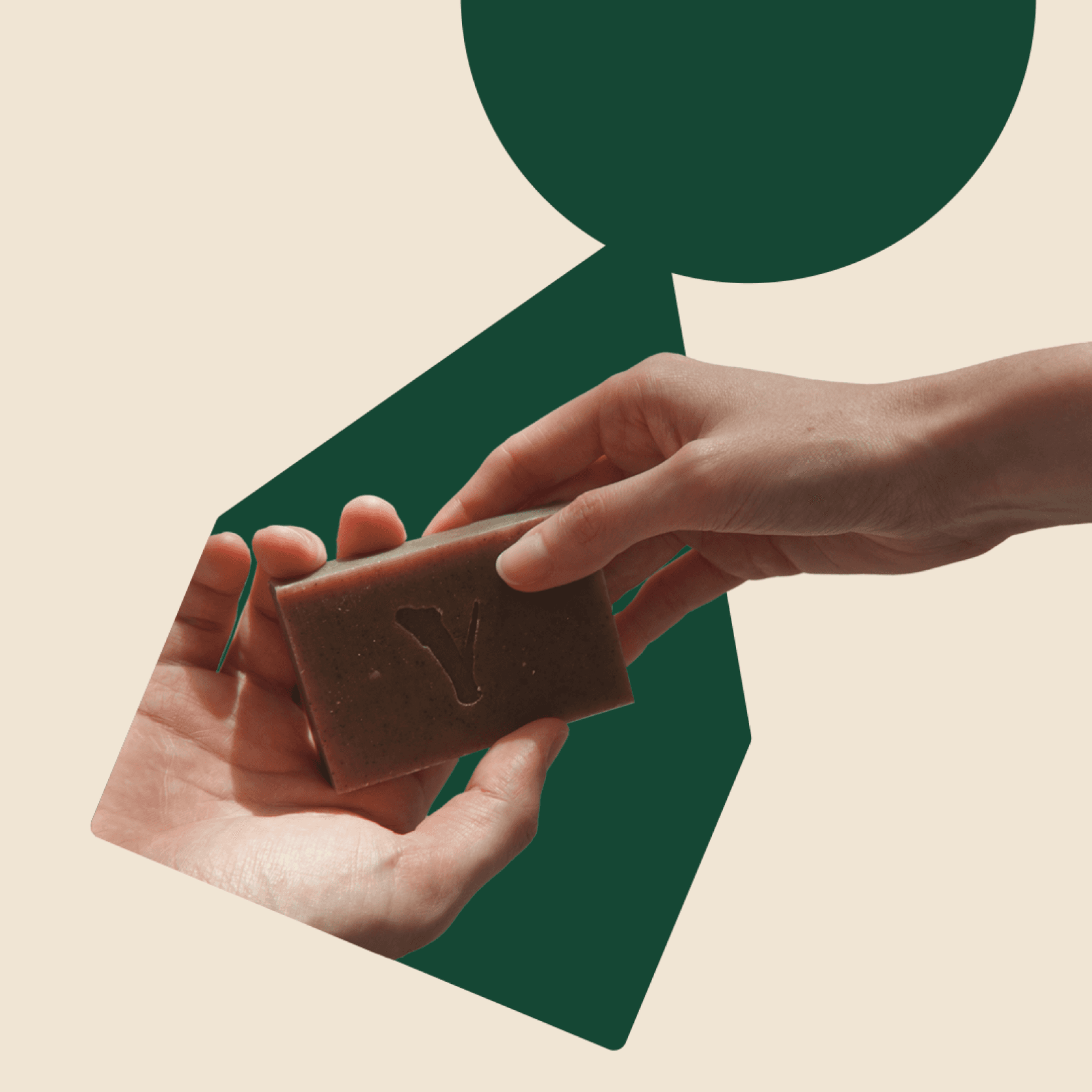 Two hands giving a piece of soap to one another inside a green logosymbol on a beige background color.