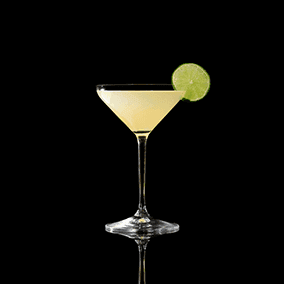 A closeup of a Kamikaze drink against a dark background.