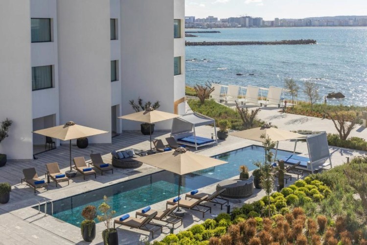 sunloungers fronting buildings near mountain