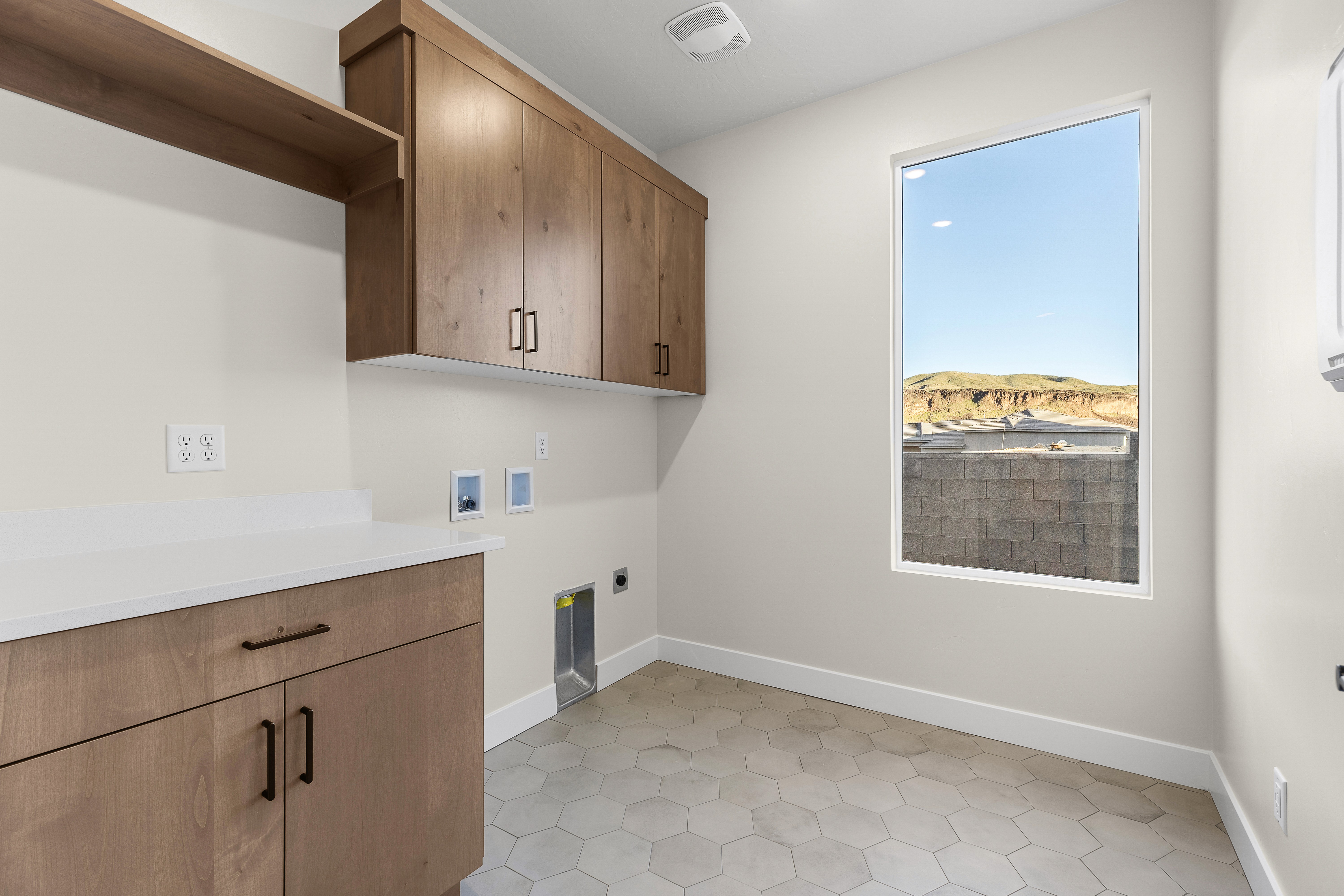 Laundry room in a custom home in Hurricane Utah with built-in cabinetry and functional layout