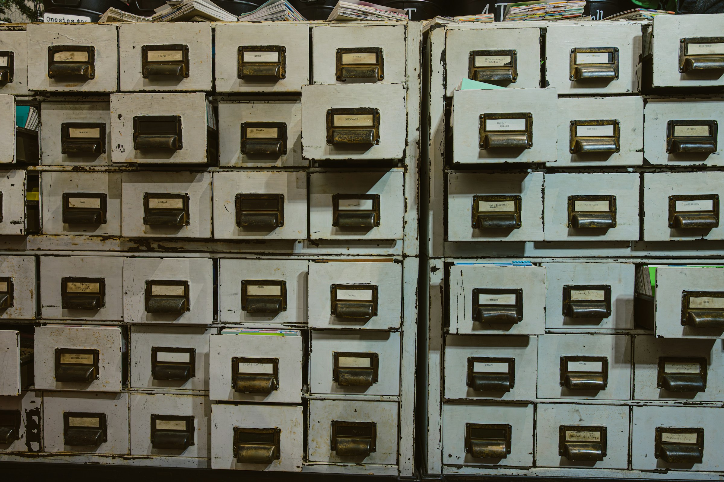 Rows of labeled filing cabinets in an institutional records repository