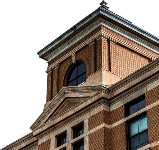 Historic brick building facade with arched windows and detailed architecture.